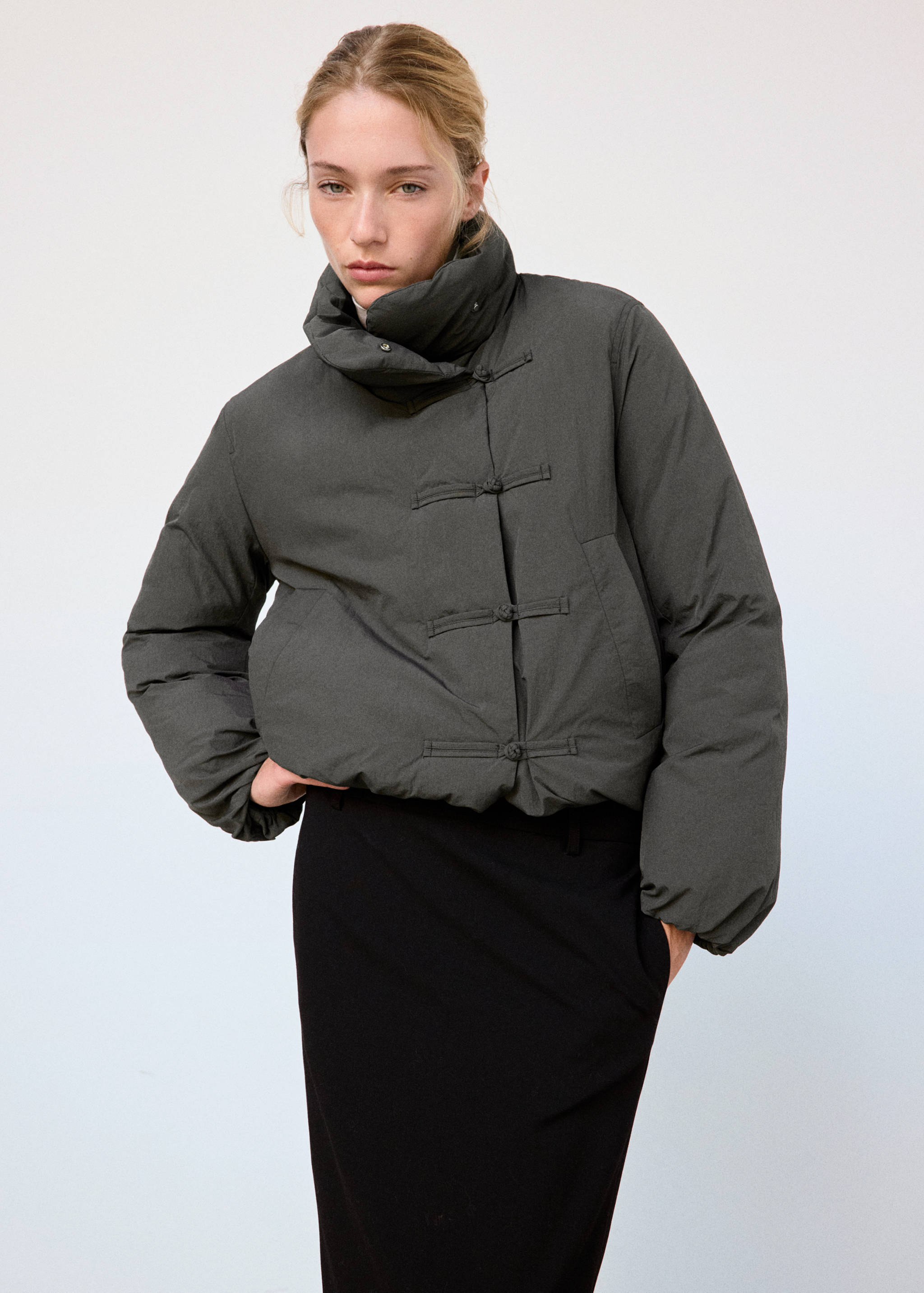 Dark grey quilted anorak with high neck and frog closures