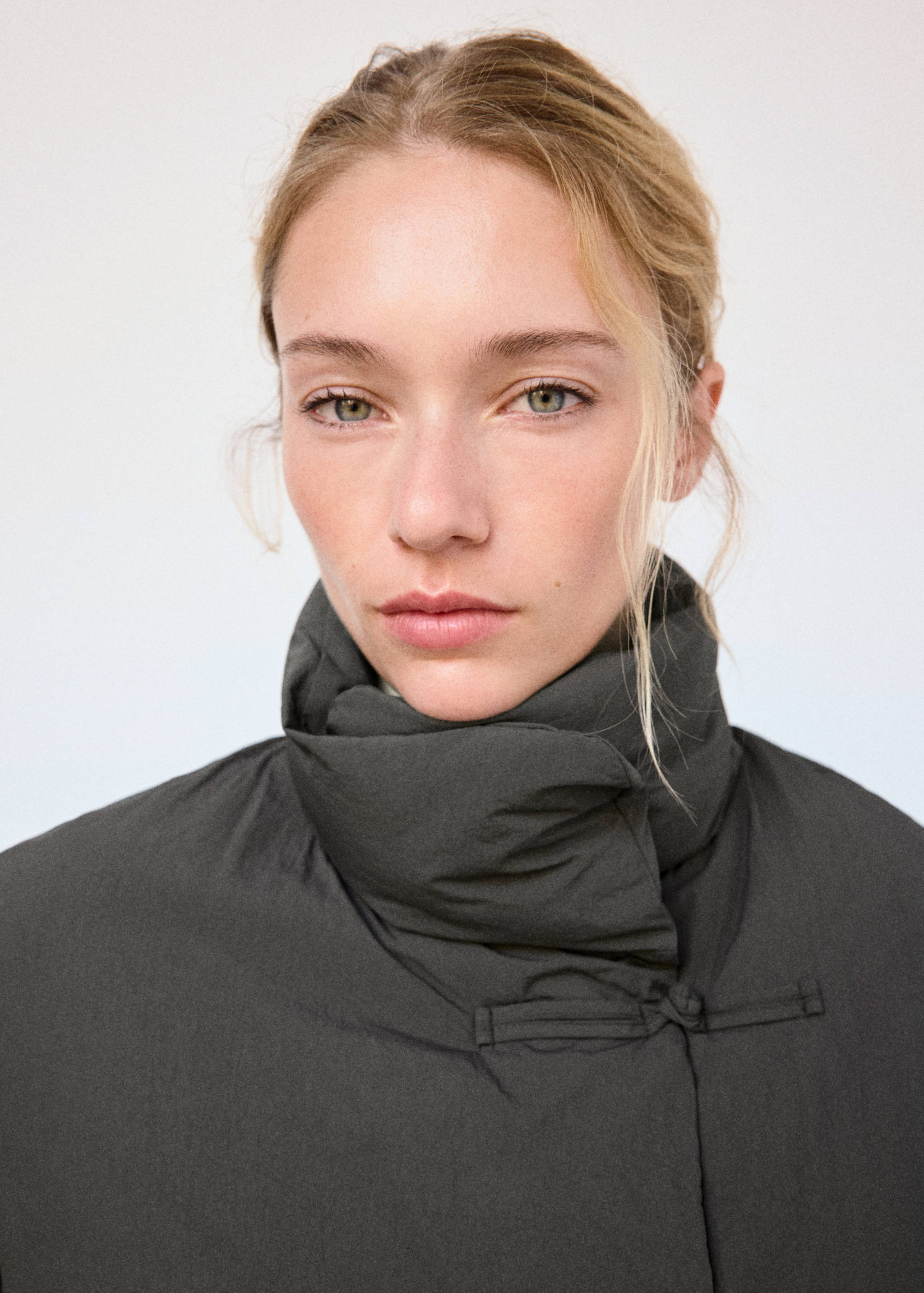 Close-up of a dark grey anorak with a high wrap-around collar.