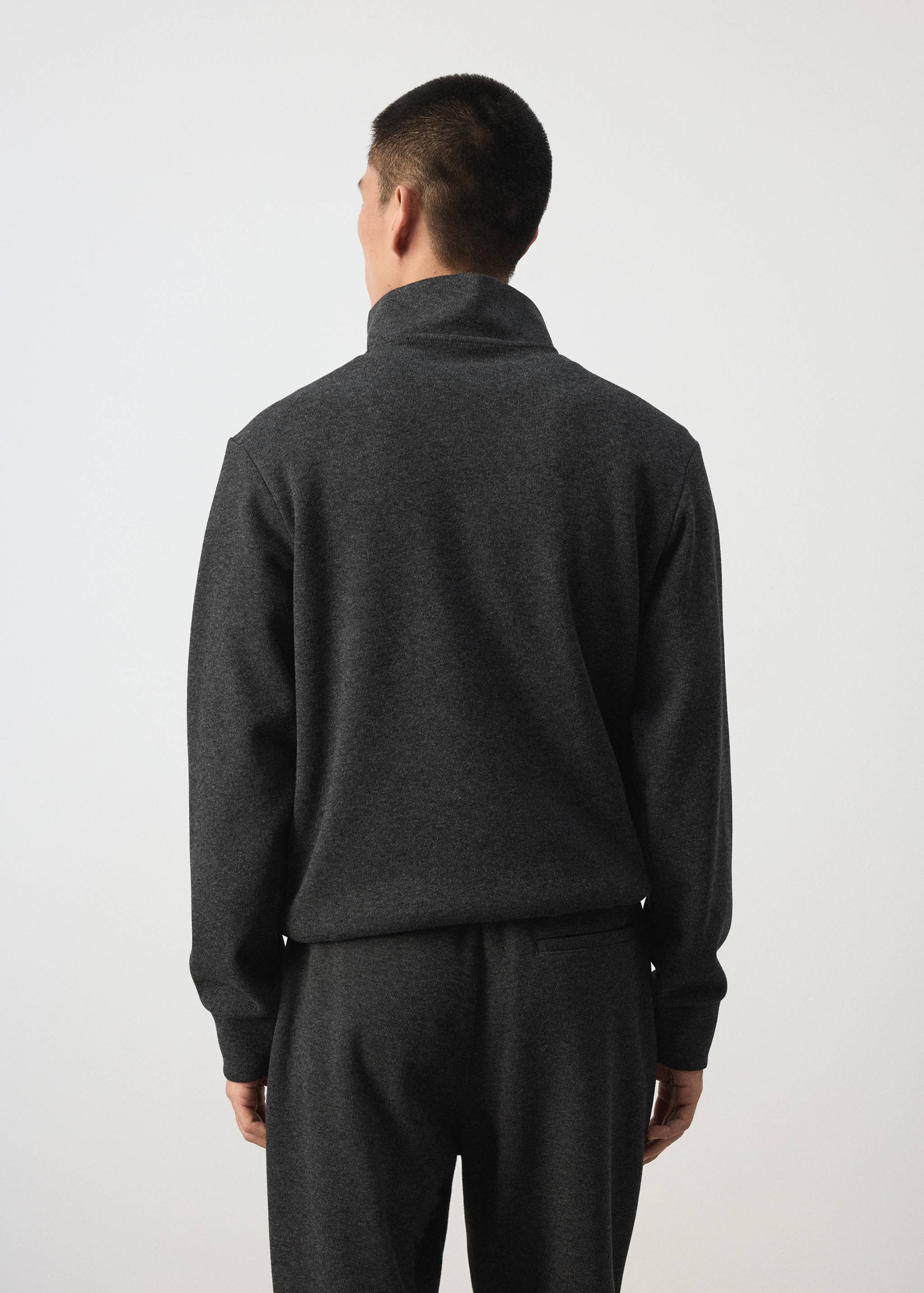 Dark grey sweatshirt with a high collar, shown from the back.