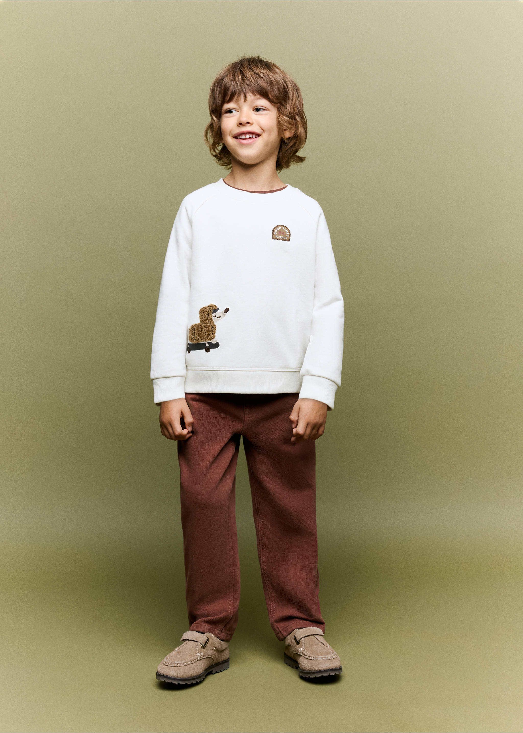 Off-white crew-neck sweatshirt with a graphic patch and faux-fur animal applique, worn with brown trousers., Off White. Ref: 37096327-00.