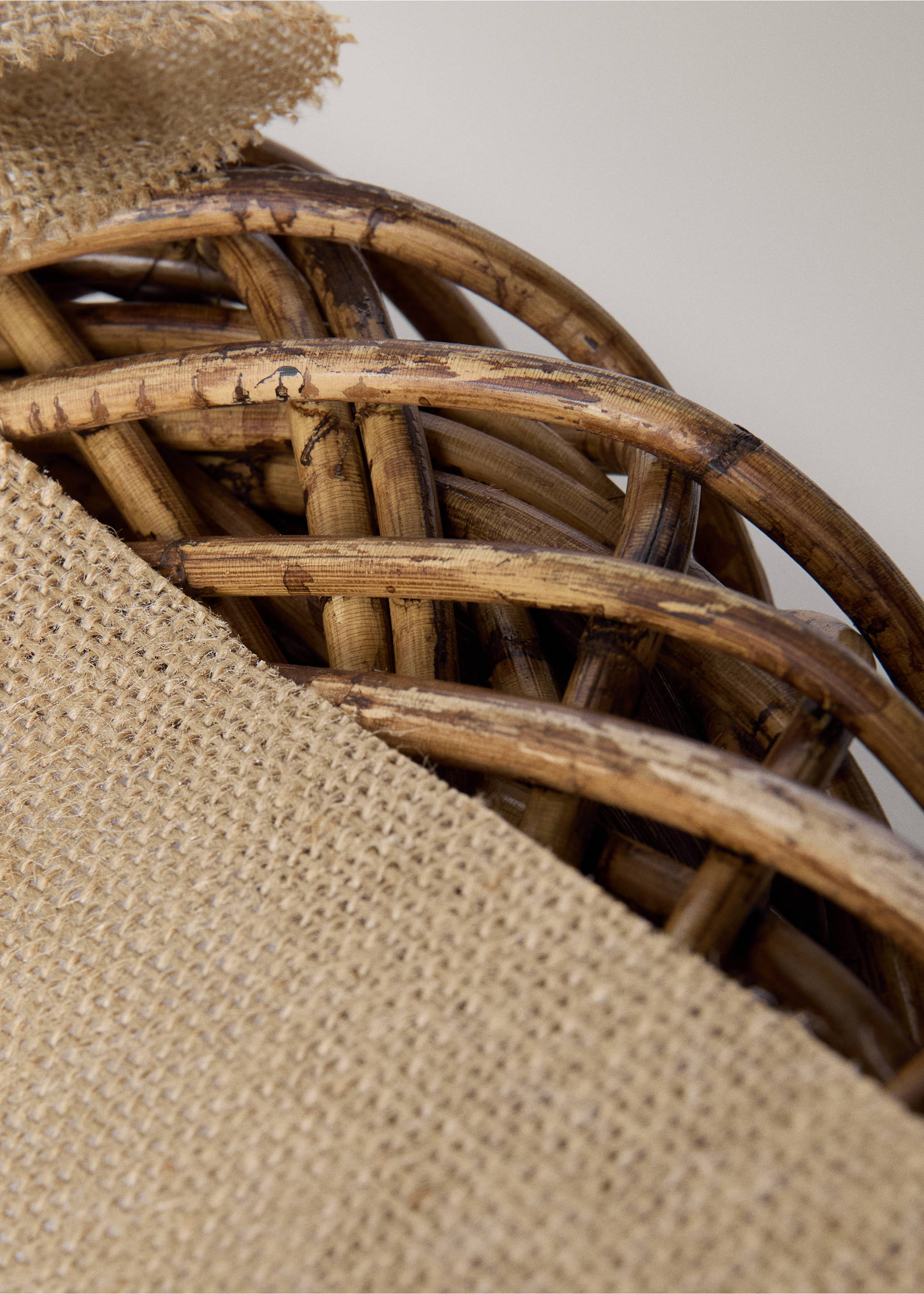 Close-up detail of a woven brown rattan home gadget with textured burlap fabric., Brown. Ref: 37096729-00.