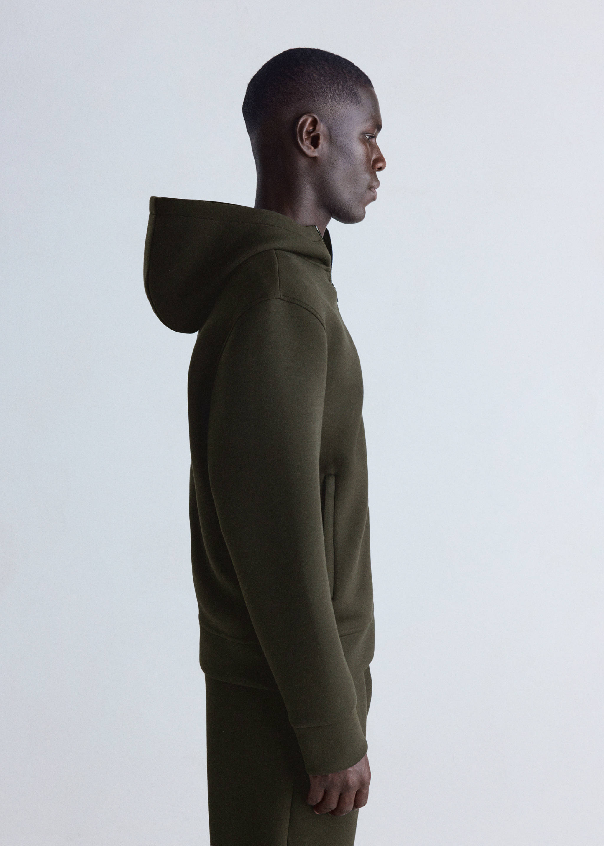 Olive green zip-up hoodie with hood and side pockets.
