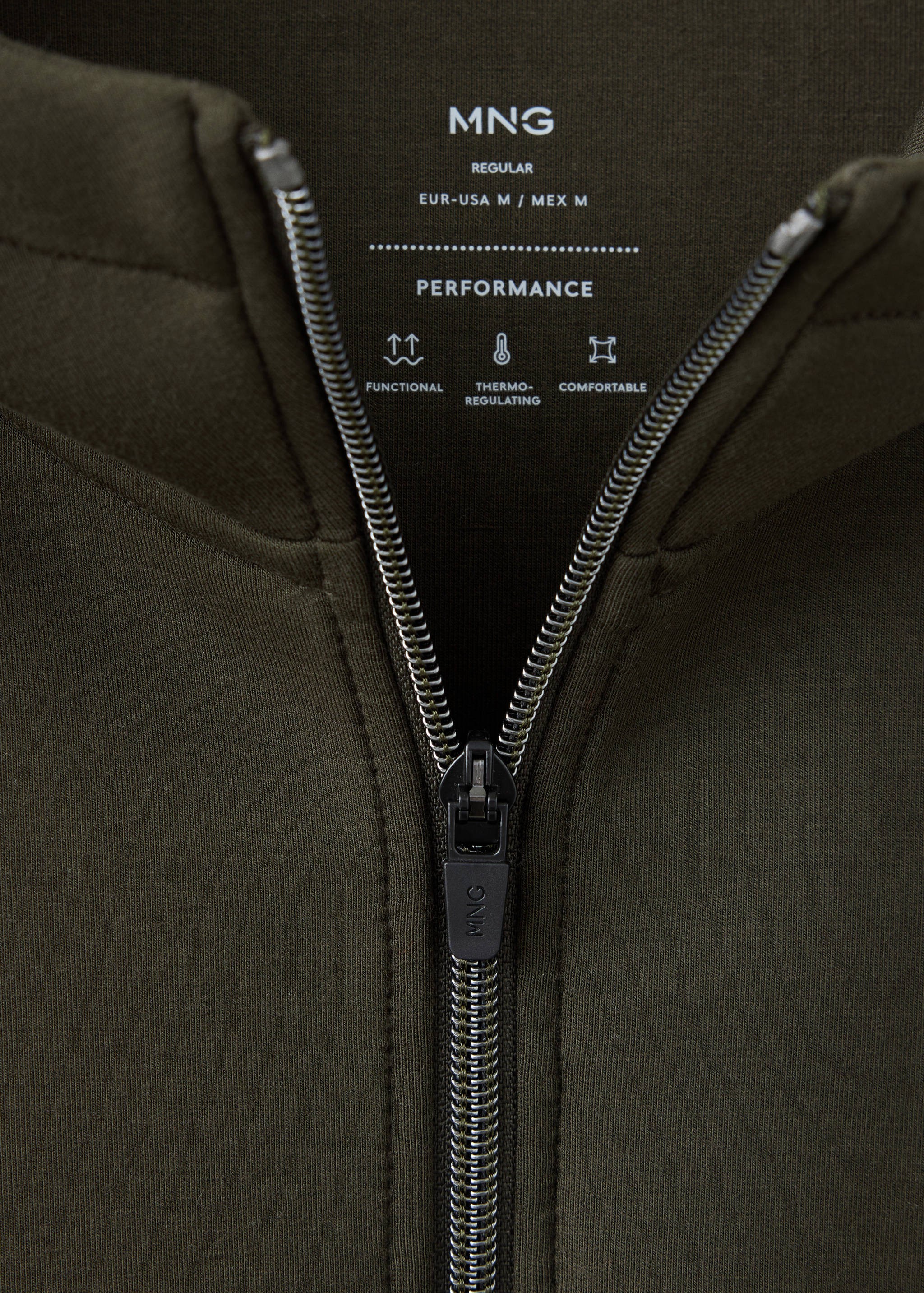 Close-up of a dark green sweatshirt collar with a central zipper and performance details.