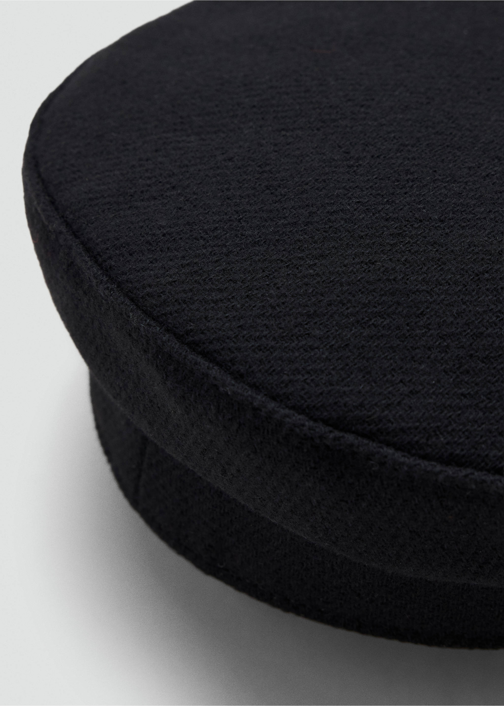 Close-up of a black cap focusing on the textured fabric detail., Black. Ref: 37097118-00.