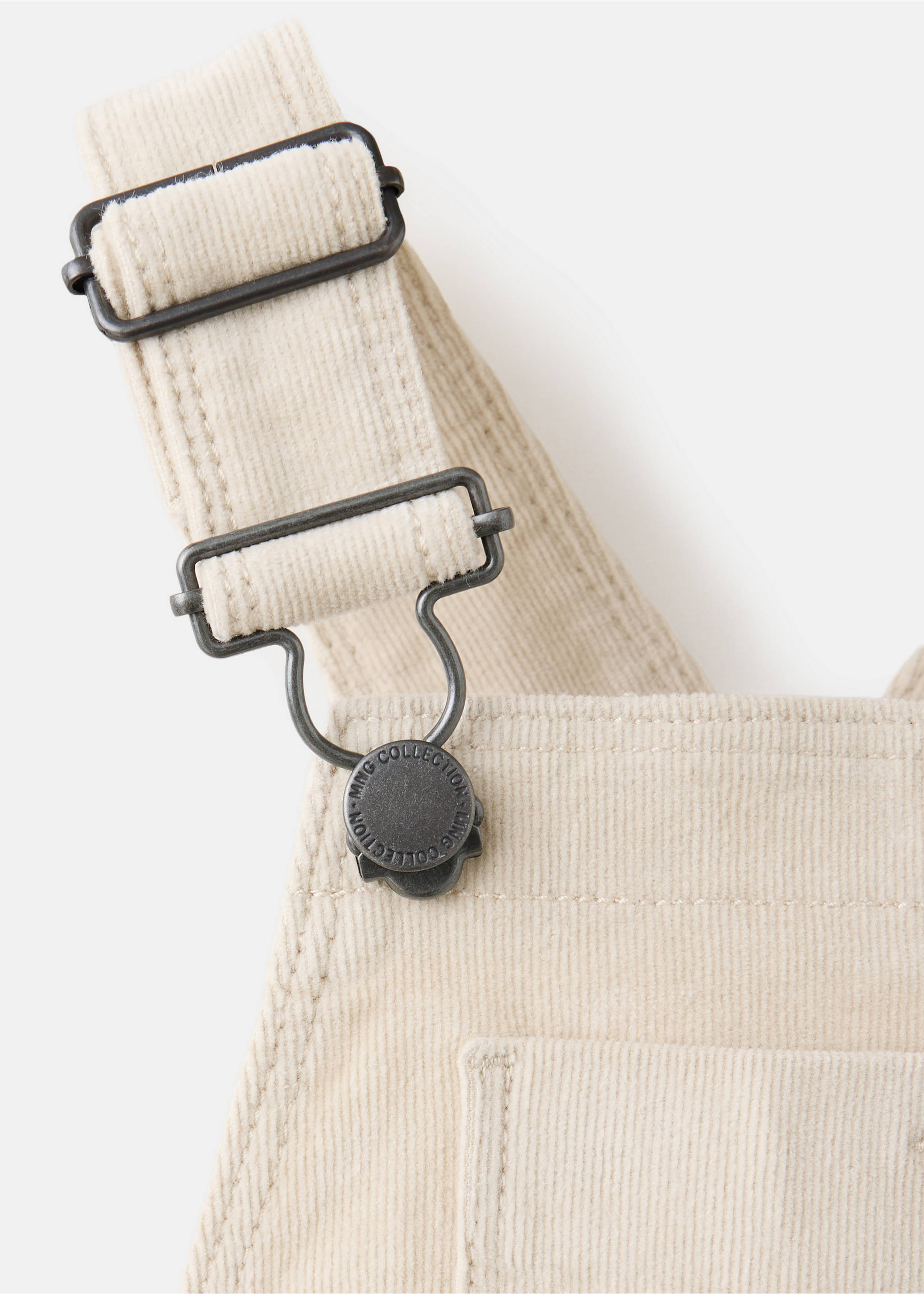 Close-up of off-white corduroy dungarees showing adjustable metallic straps and chest pocket detail., Beige. Ref: 37097124-00.