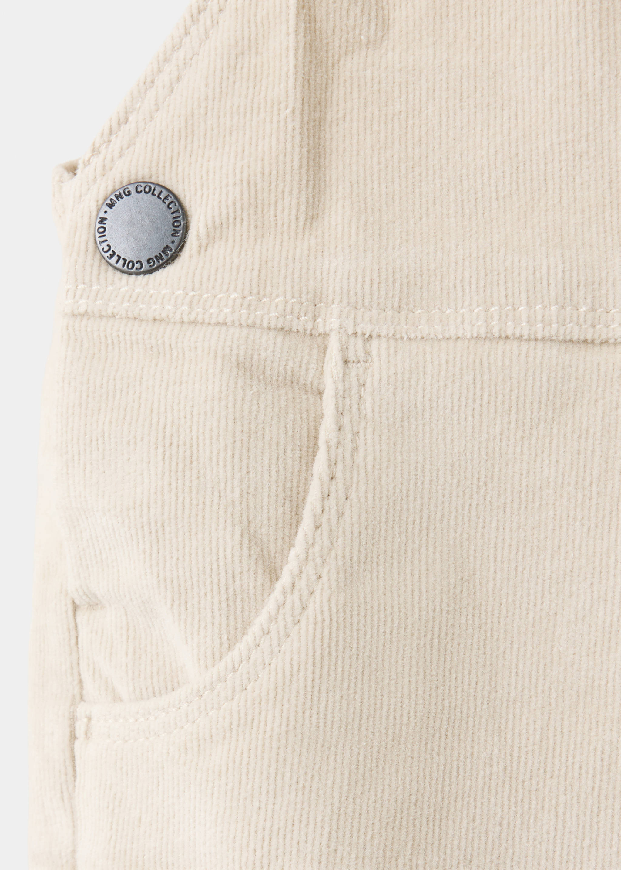 Cream corduroy dungarees fabric and pocket detail