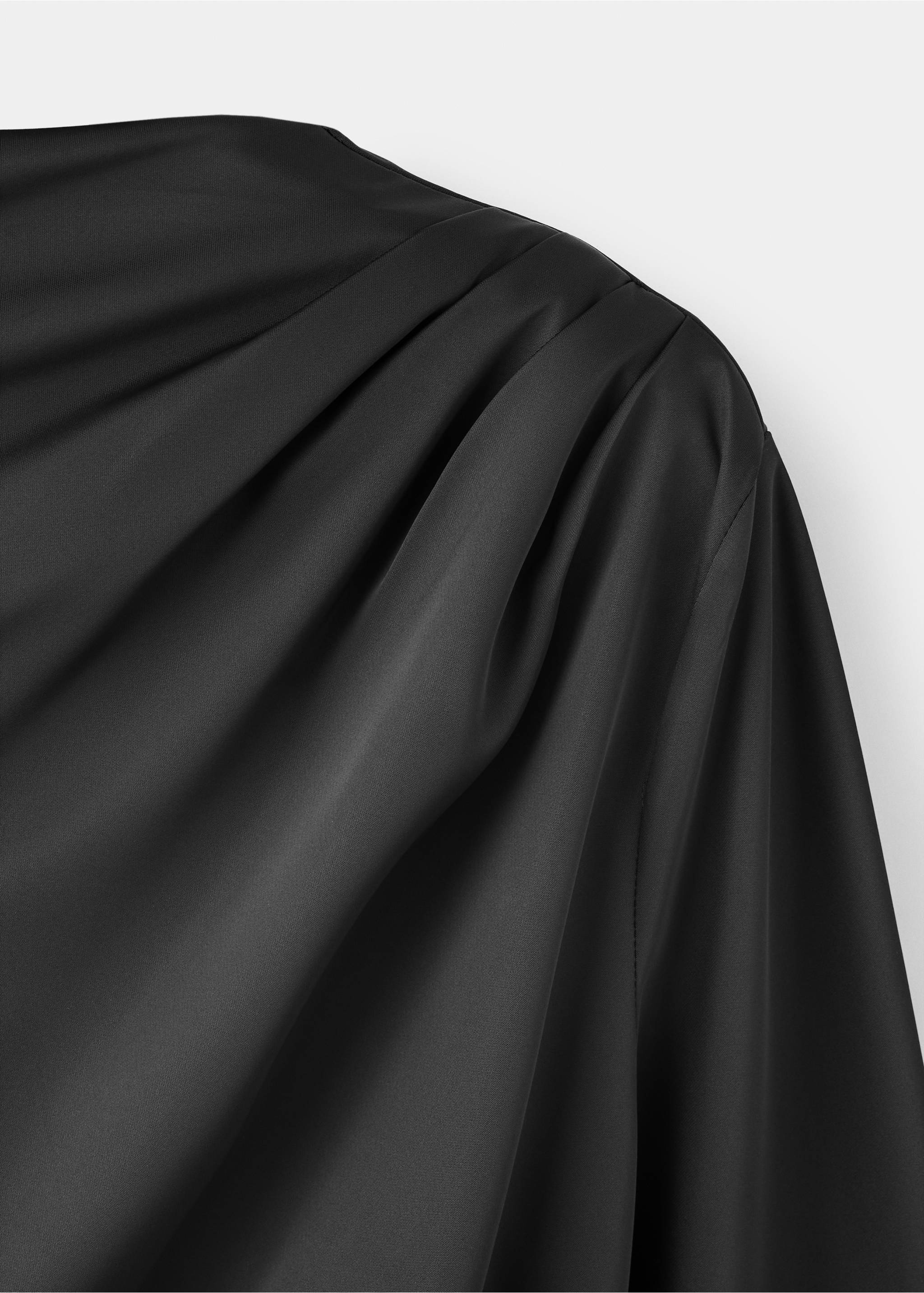 Black dress detail featuring draped shoulder design., Black. Ref: 37097781-00.