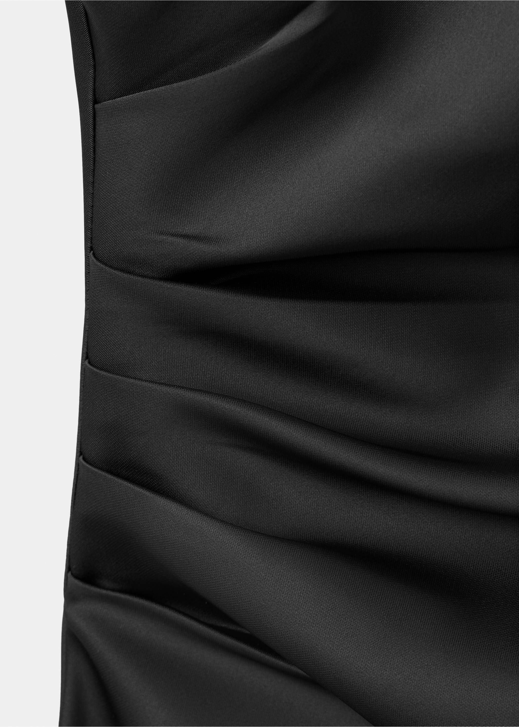 Close-up of ruched fabric detail on a black dress., Black. Ref: 37097781-00.
