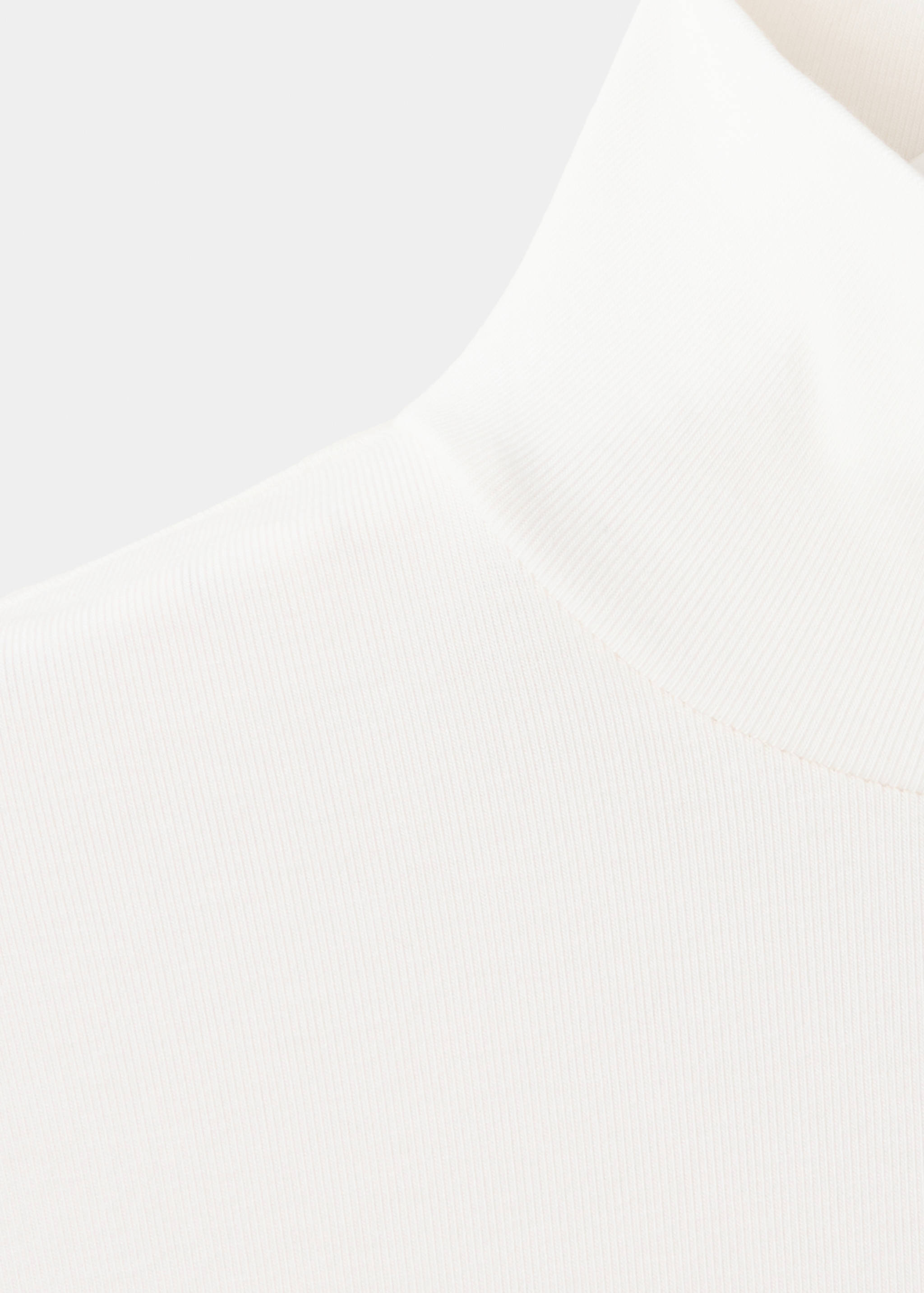 Close-up of a white ribbed T-shirt with a high neck.