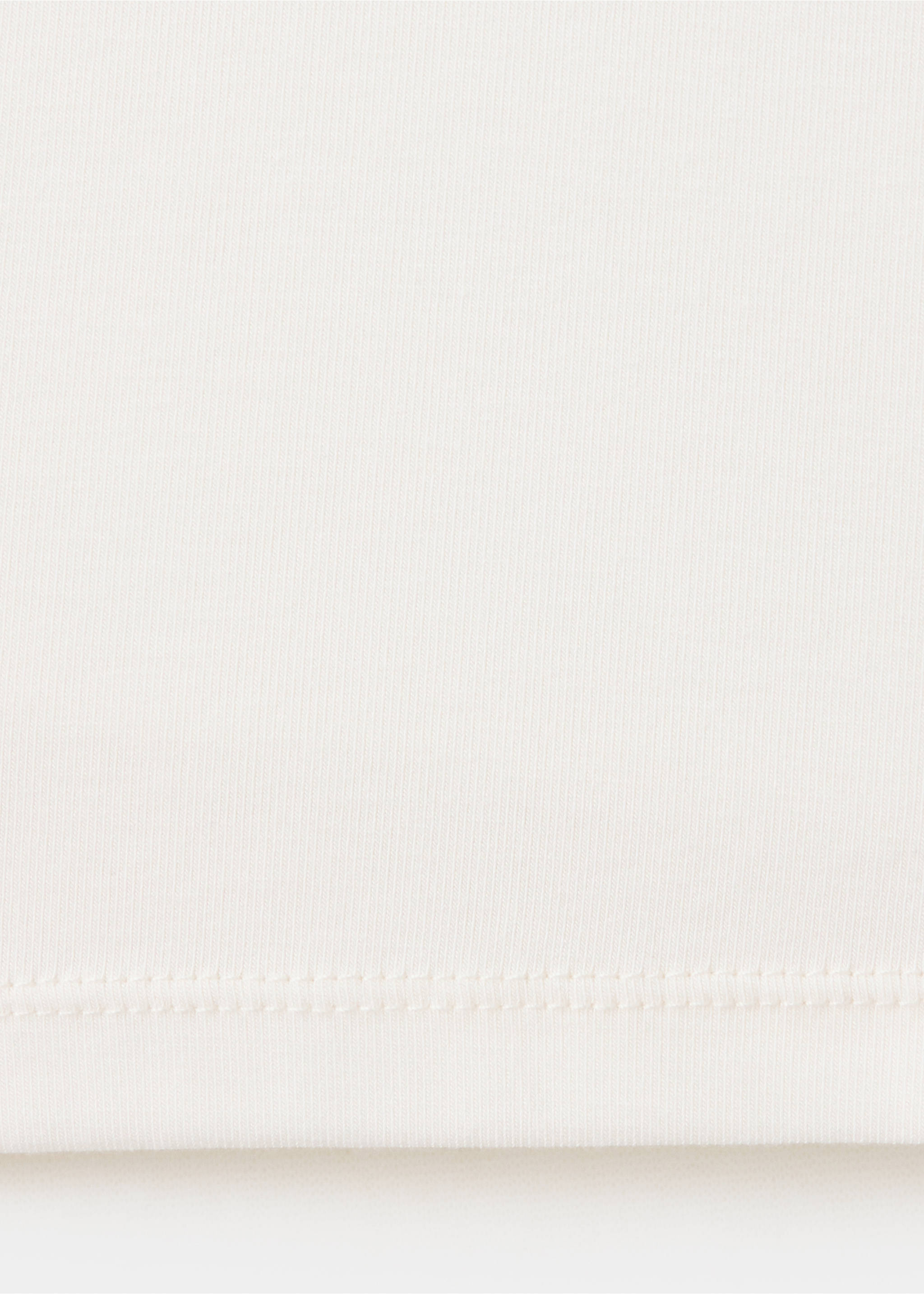Close-up of the white t-shirt fabric texture and hem., Off White. Ref: 37097782-00.