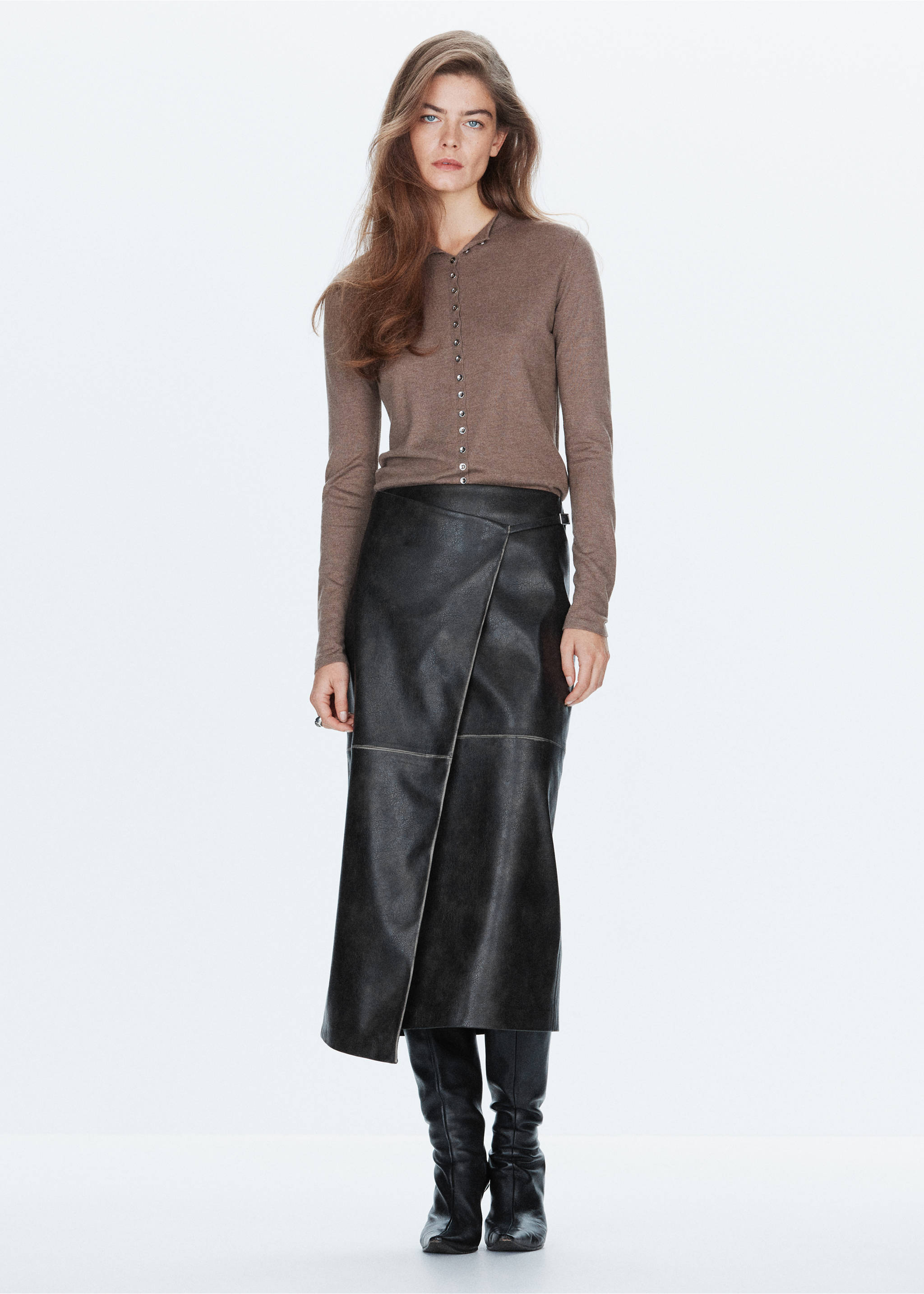 Black faux-leather midi skirt with a diagonal wrap front, styled with a brown top, Black. Ref: 37097787-00.