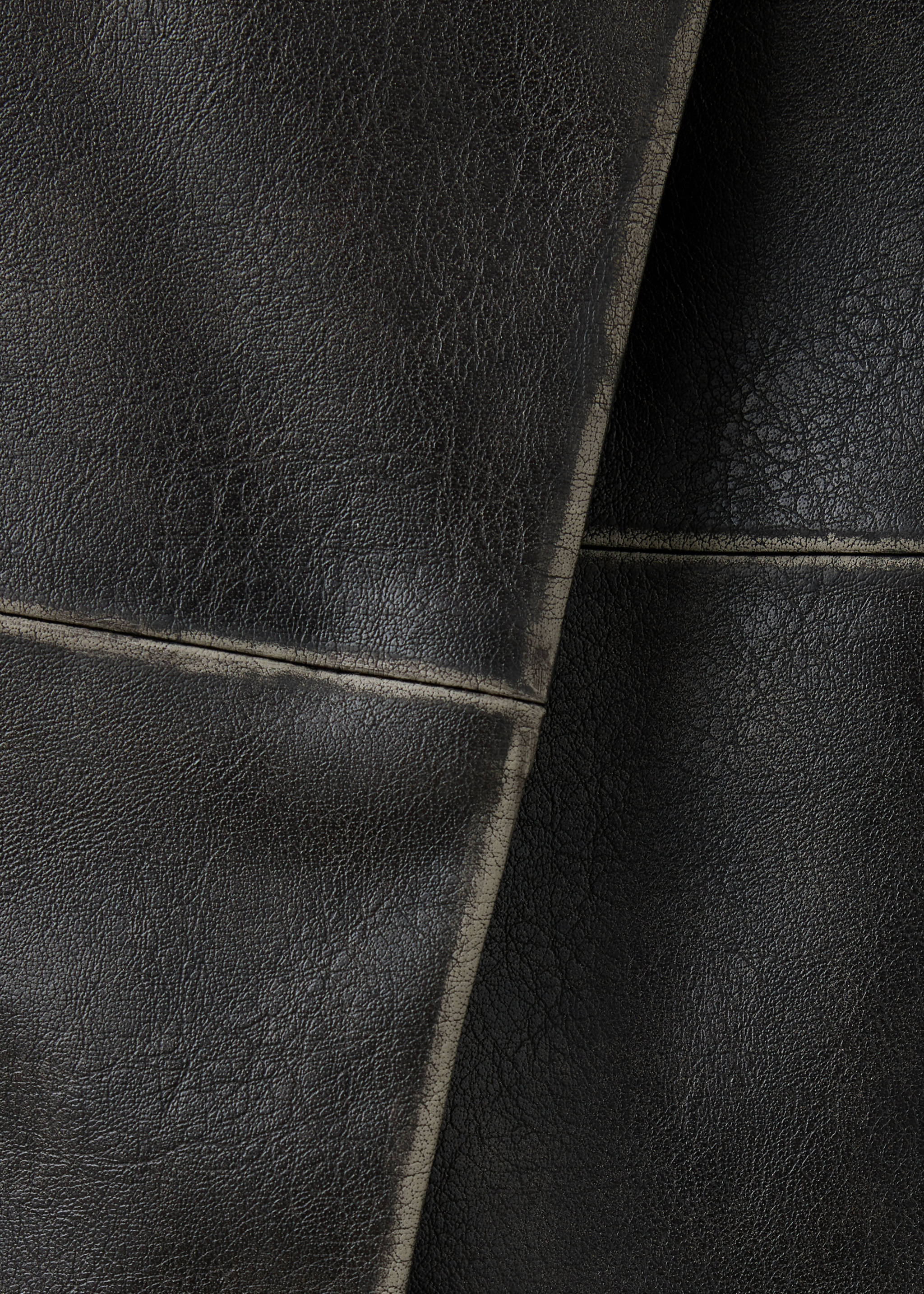 Close-up of the dark brown skirt fabric texture and panel seams.