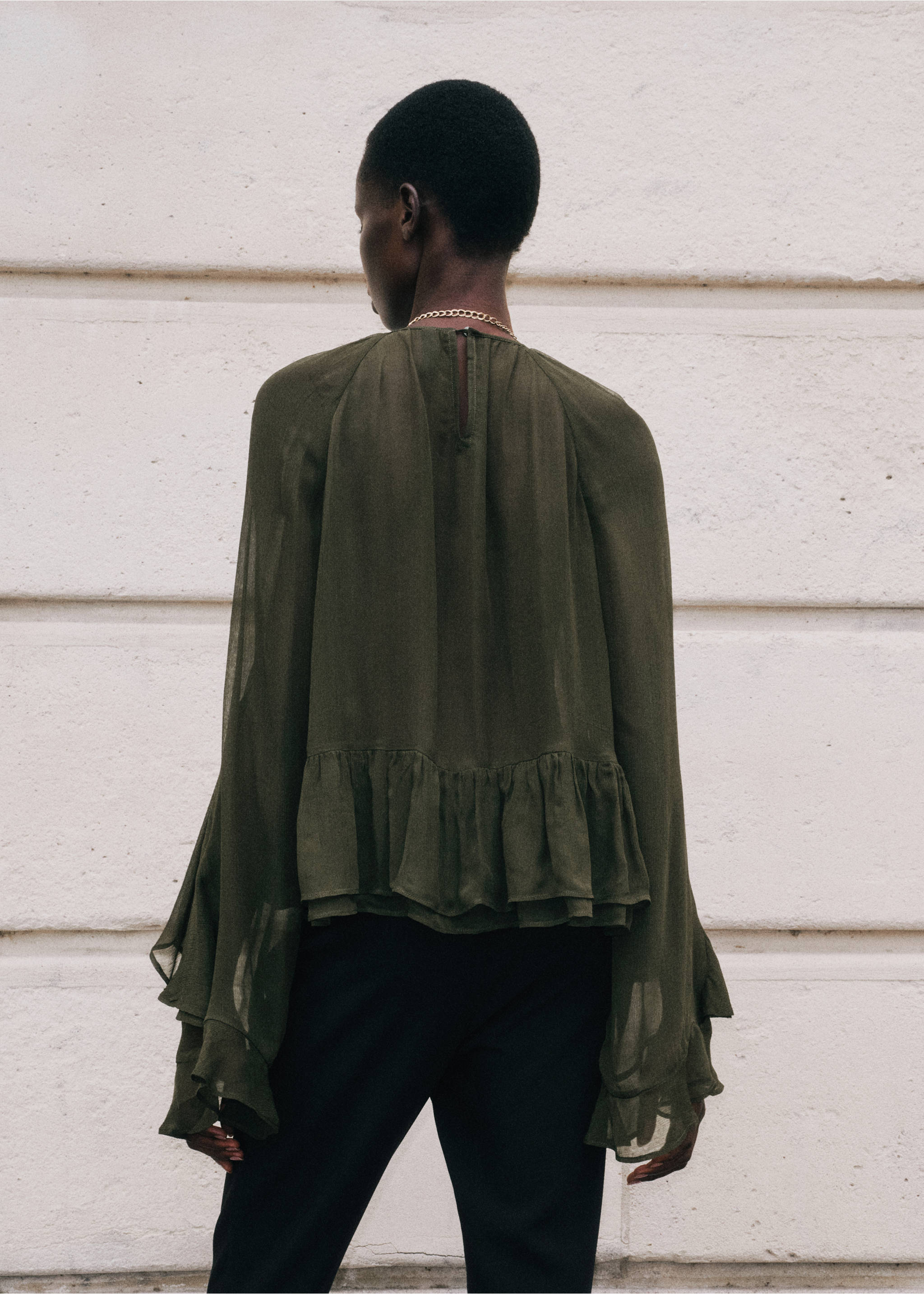 Back view of a dark olive green blouse with flared ruffled sleeves and a ruffled hem., Green. Ref: 37097788-00.