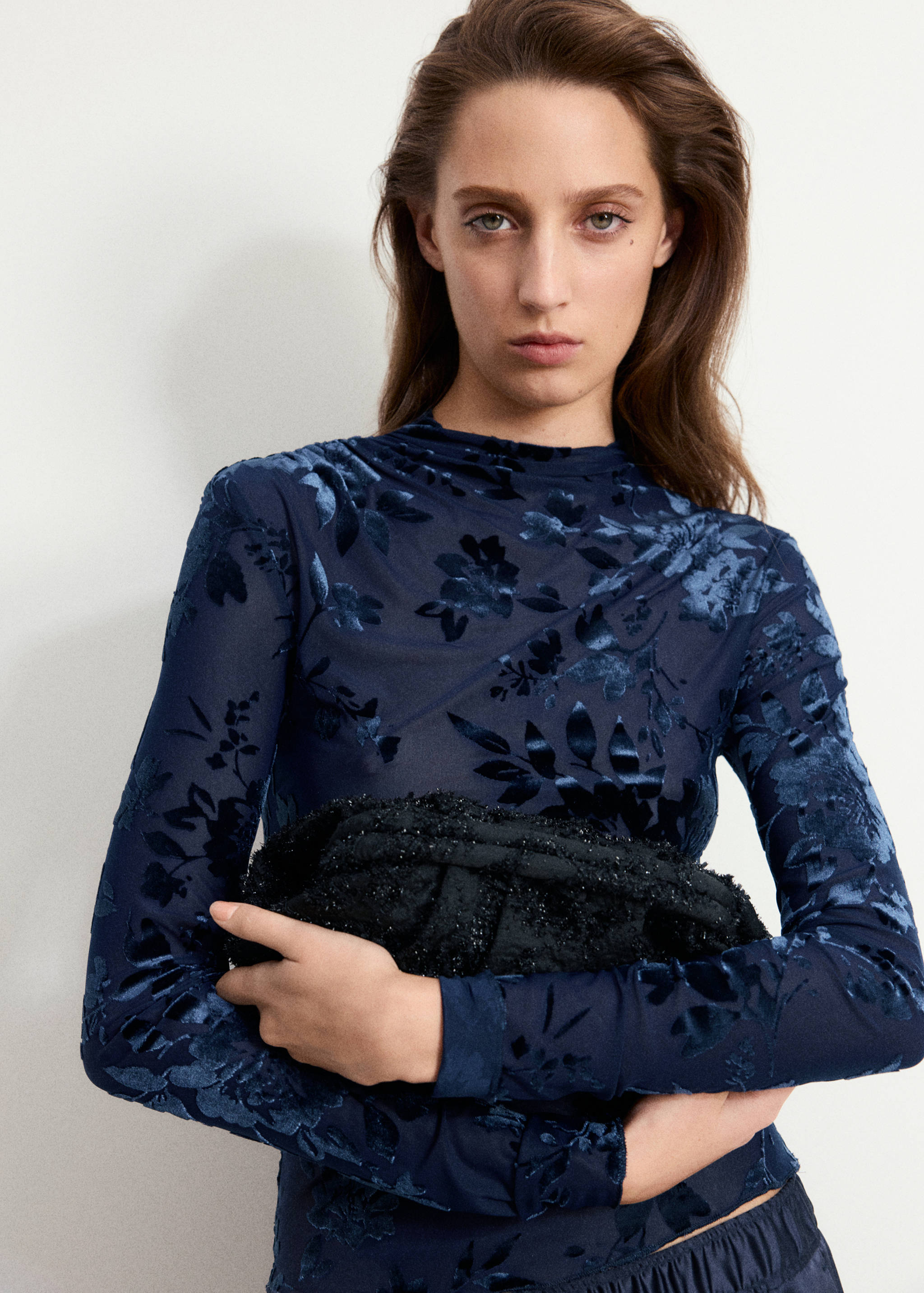 Dark blue long-sleeved high-neck top in floral velvet burnout.