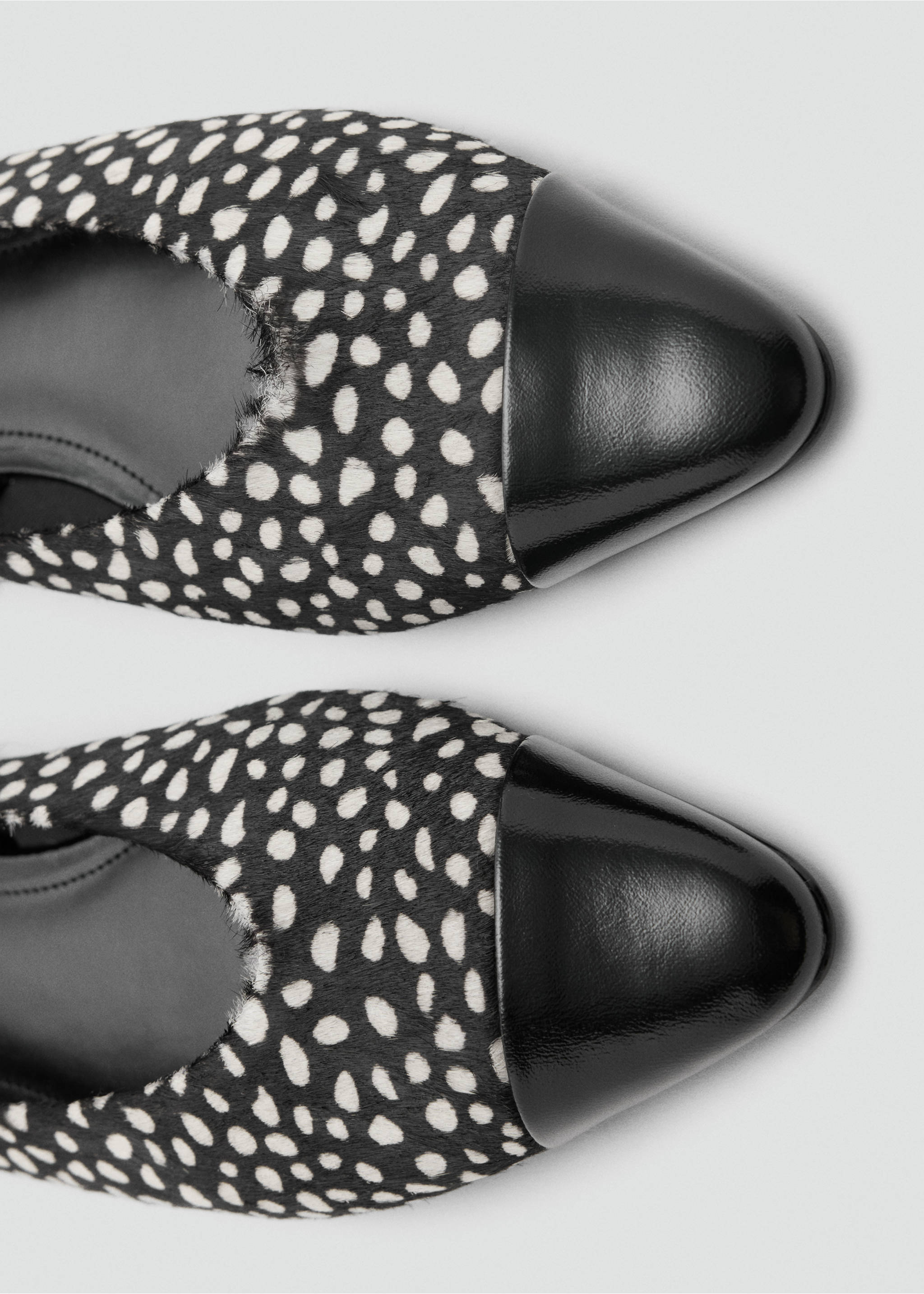Close-up of black and white animal print faux-fur shoes with black patent toe caps., Black. Ref: 37097792-00.