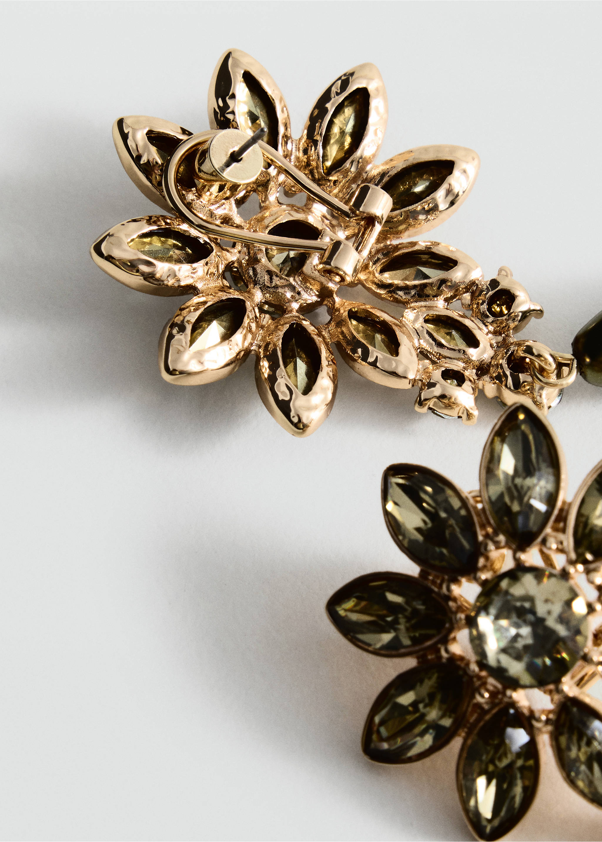 Close-up of gold-toned flower earrings with faceted olive-green crystals., Pastel Green. Ref: 37097793-00.