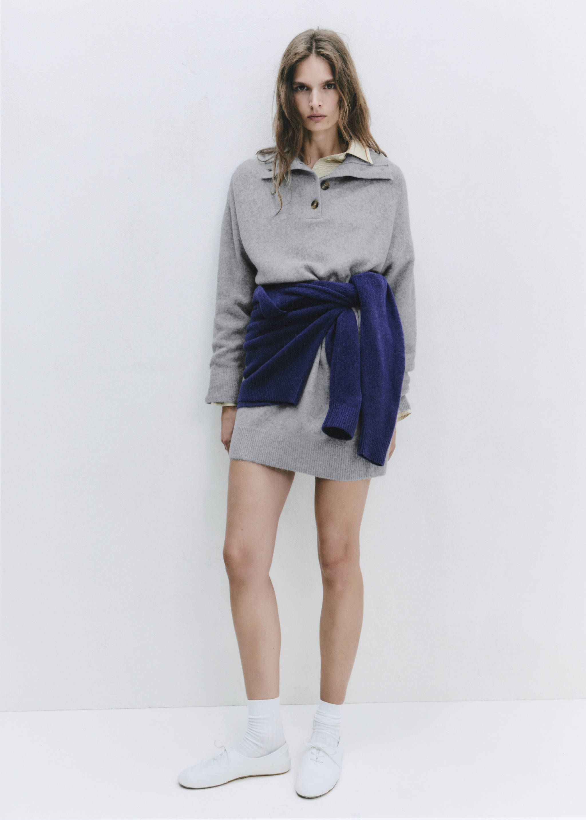 Grey knit polo dress layered with a shirt and a purple jumper tied at the waist
