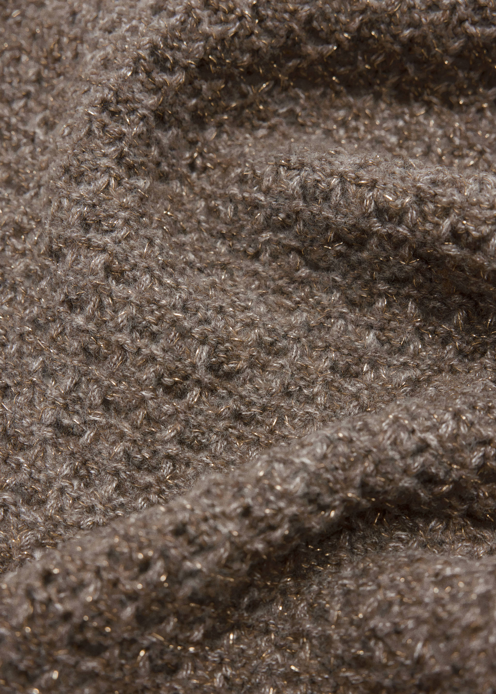 Close-up of a textured greyish-brown knit scarf with metallic threads.