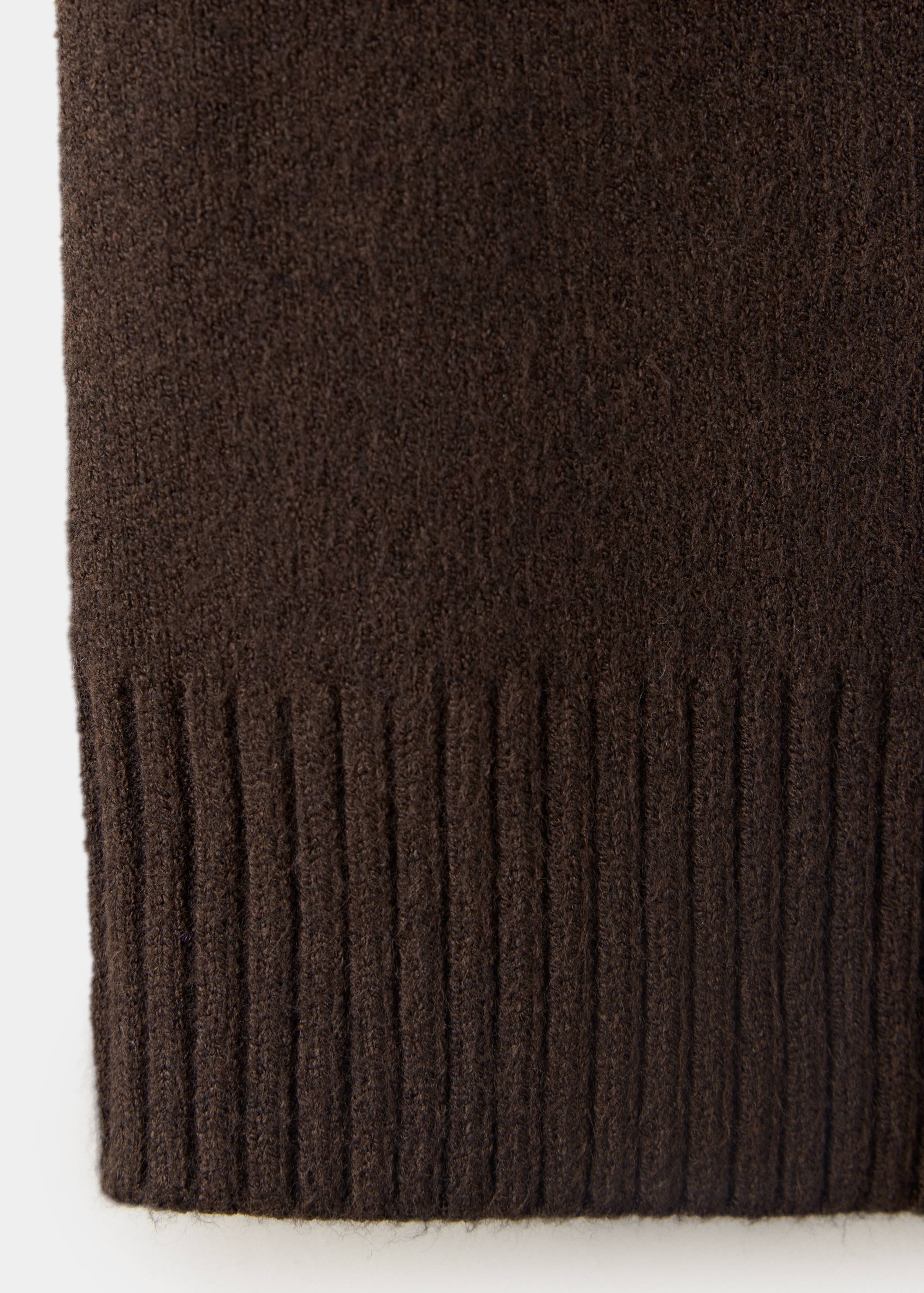 Brown jacket fabric detail showing the soft knit texture and ribbed hem.