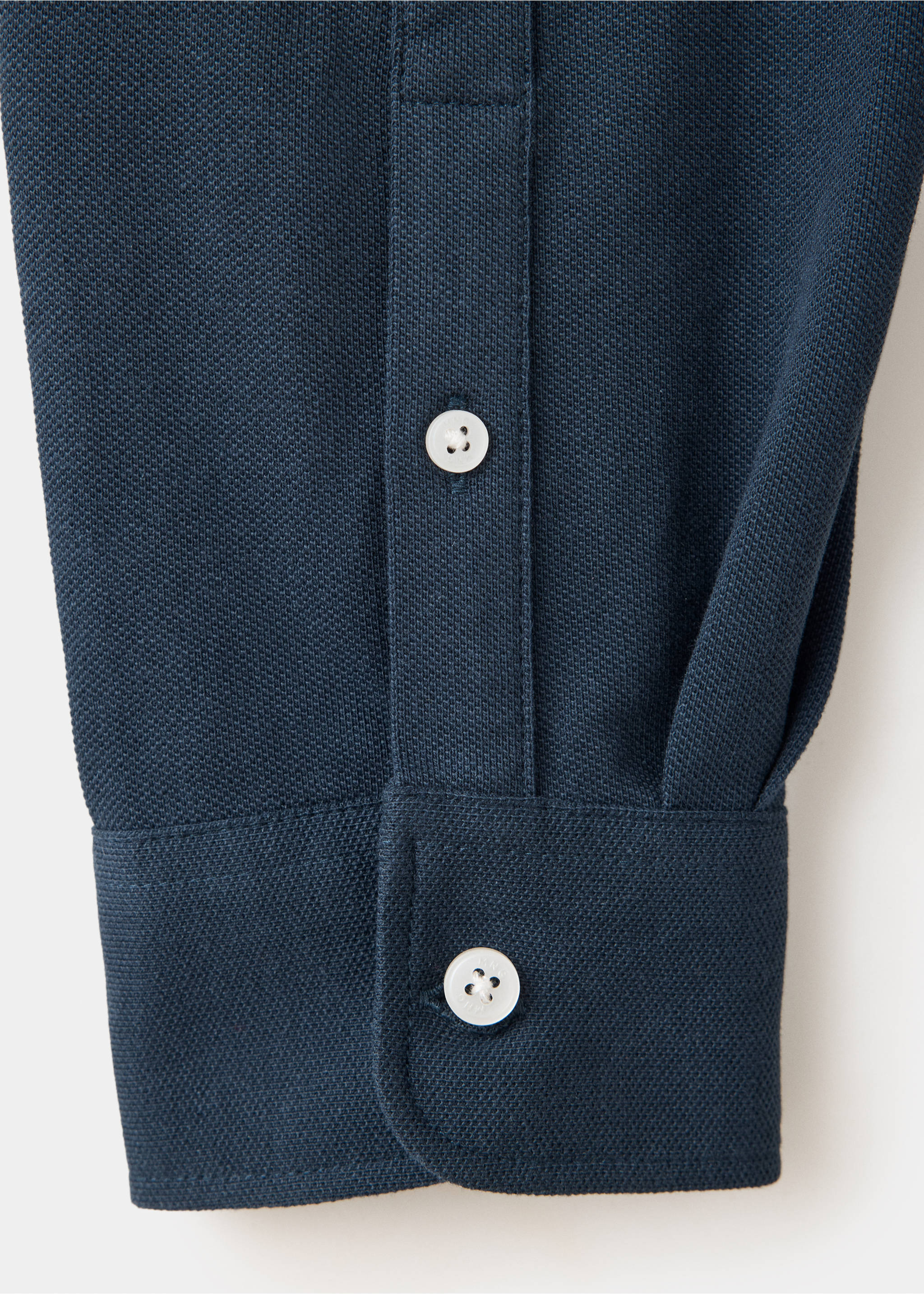 Dark navy blue polo shirt texture detail showing the buttoned cuff., Navy. Ref: 37097805-00.
