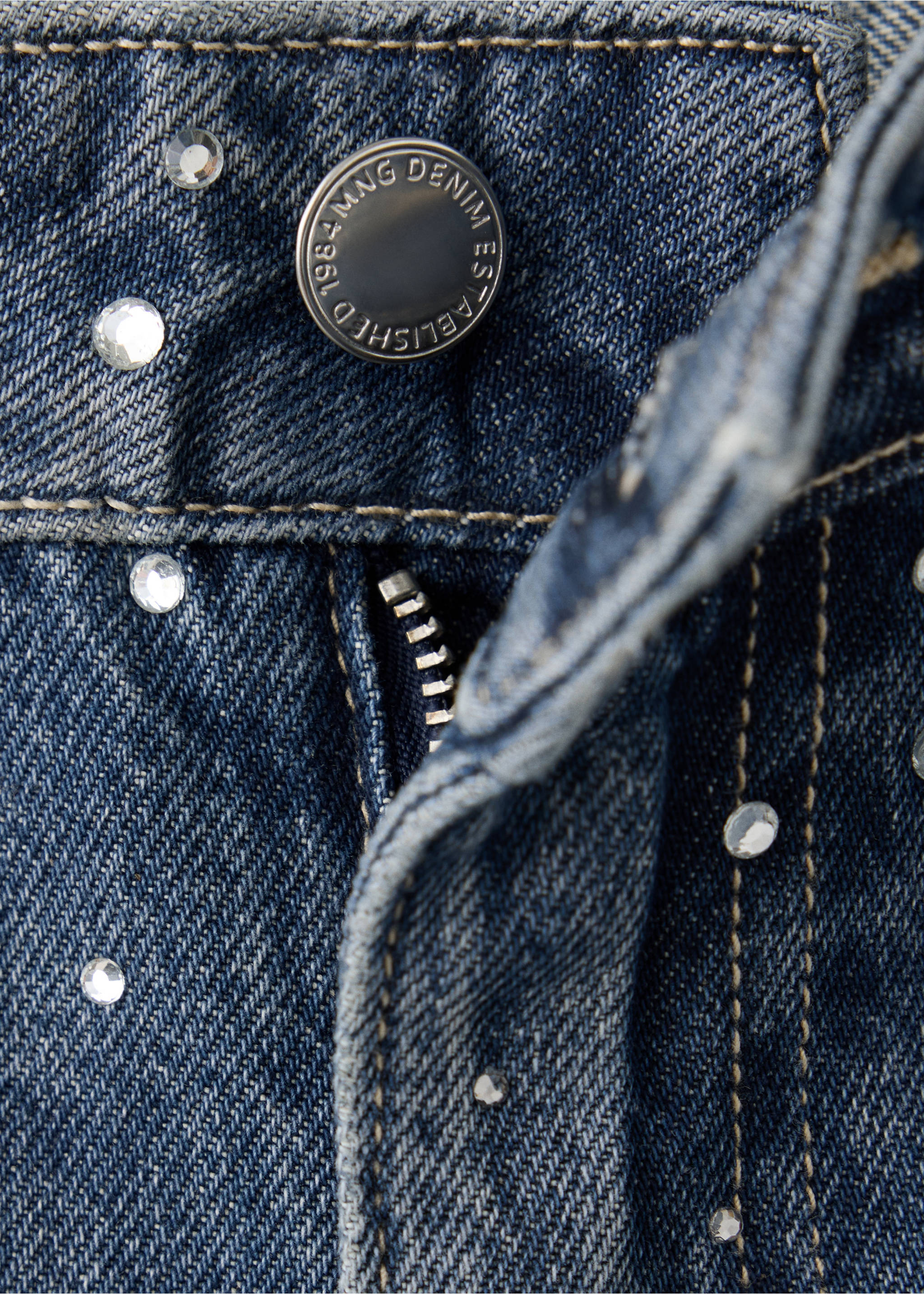 Blue denim trousers detail featuring rhinestones and a metal button., Dark Blue. Ref: 37097807-00.