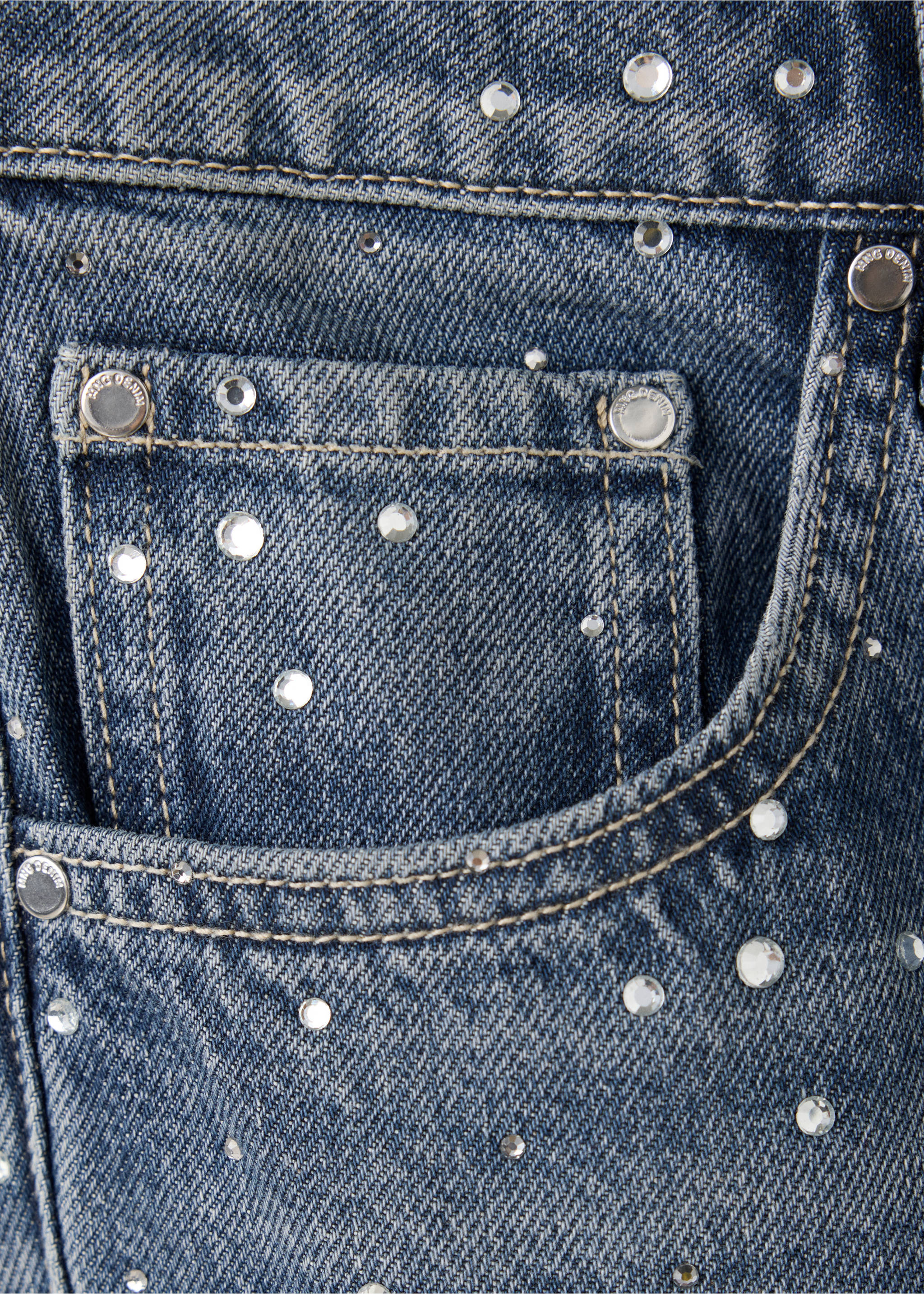 Close-up of blue denim trousers with scattered rhinestone embellishments., Dark Blue. Ref: 37097807-00.