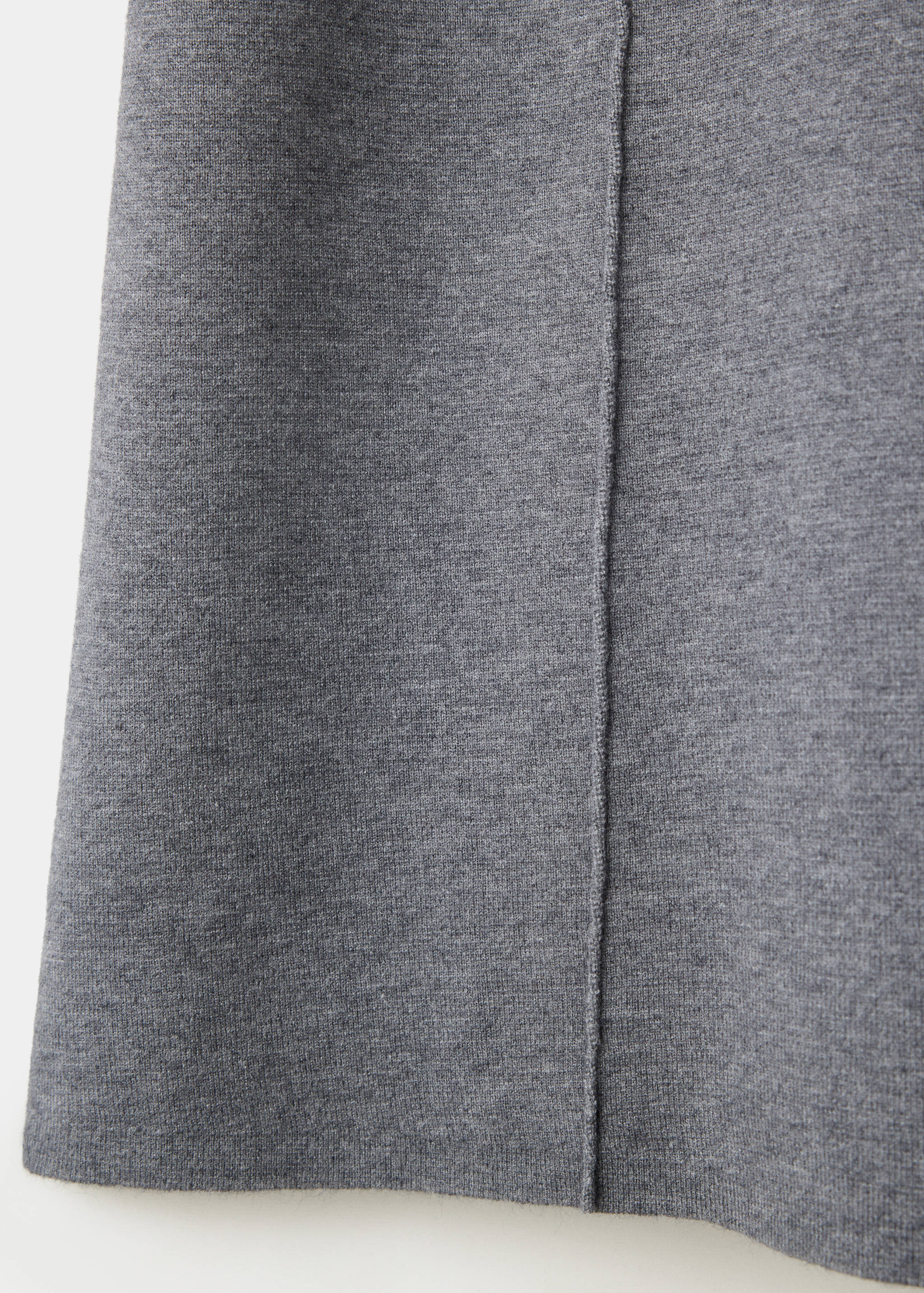 Close-up of grey dress fabric texture with a vertical seam.