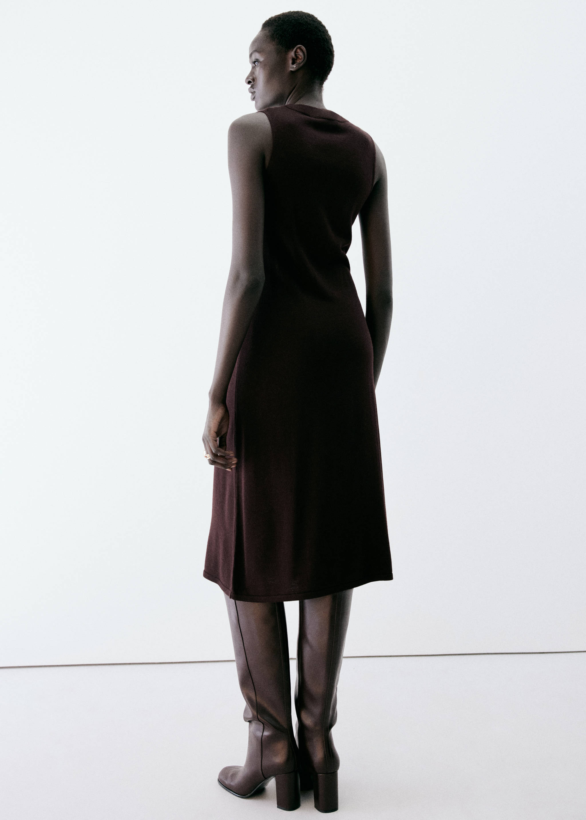 Dark burgundy sleeveless knit midi dress shown from the back.