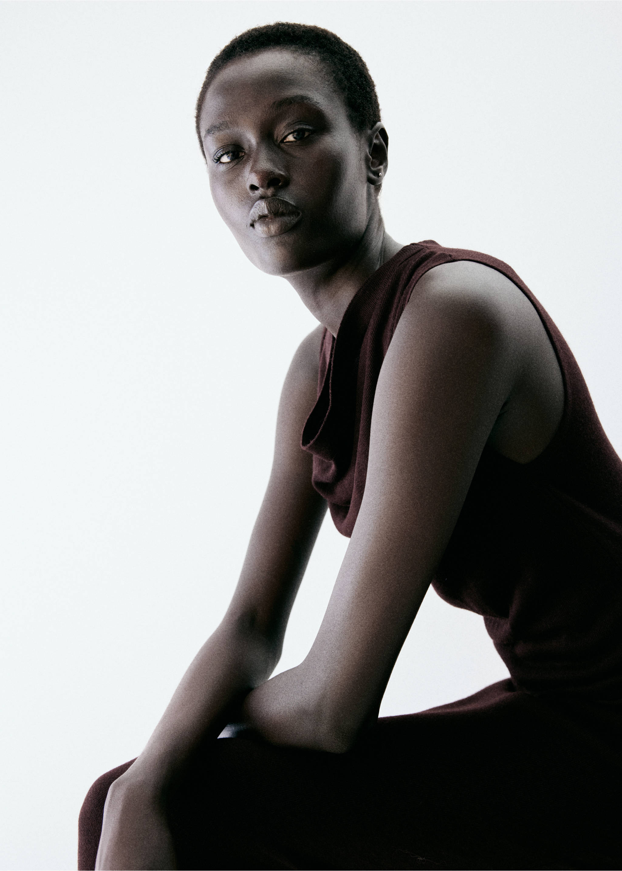 Burgundy sleeveless dress with cowl neck, shown in a close-up with the model's face., Burgundy. Ref: 37097811-00.