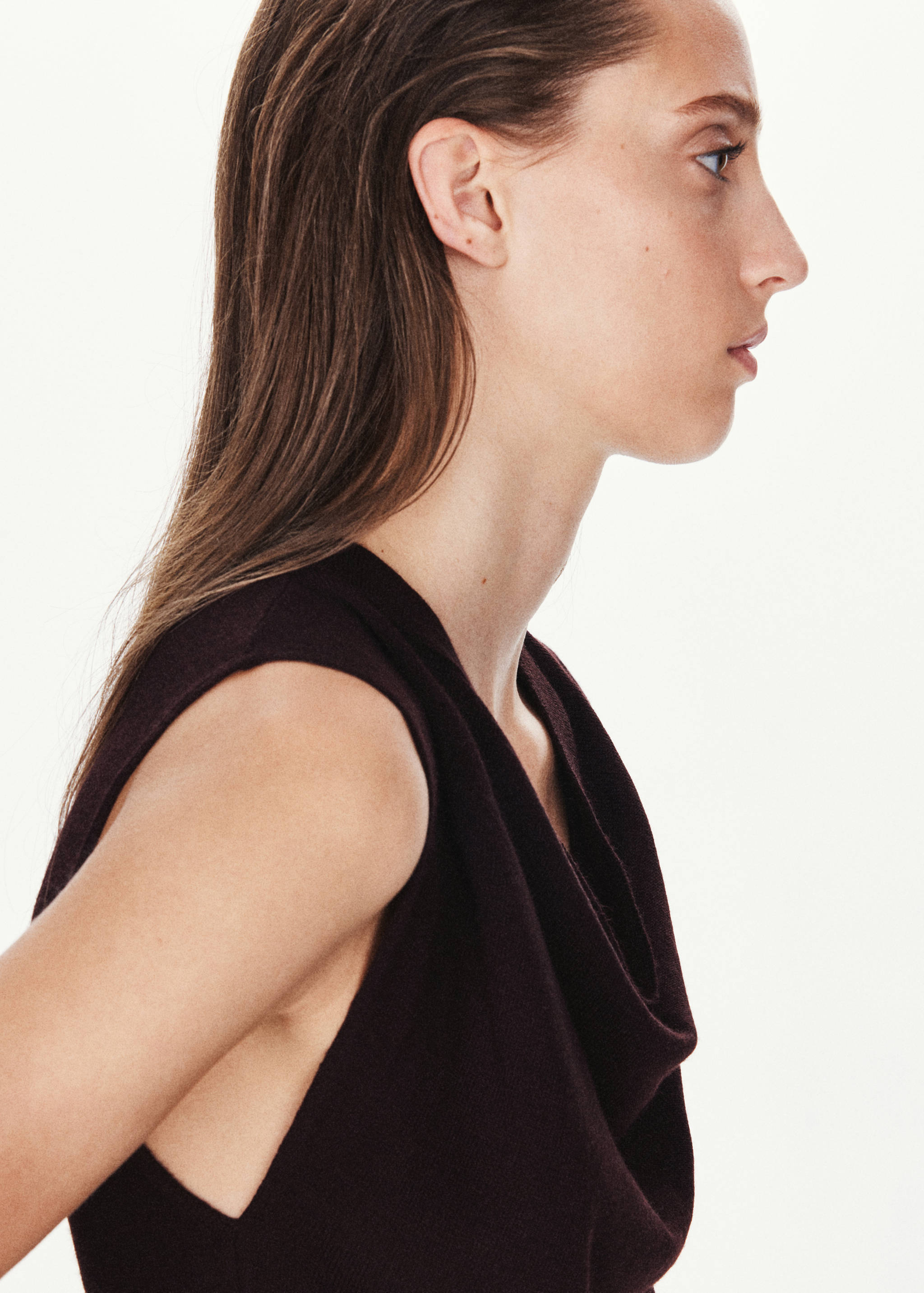 Dark plum sleeveless dress with a draped cowl neckline, shown in close-up profile.