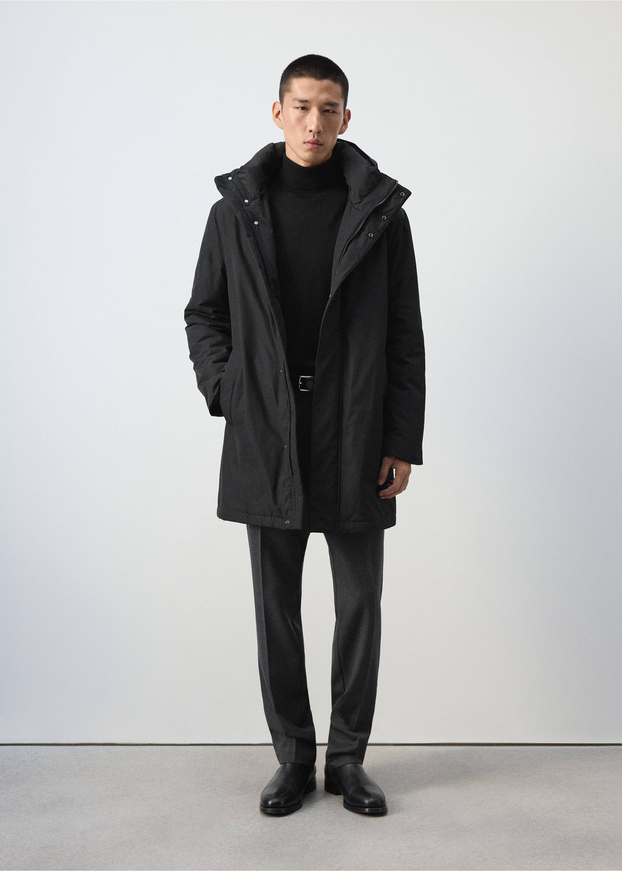 Black hooded parka worn over a black turtleneck and dark grey trousers., Black. Ref: 37097882-00.