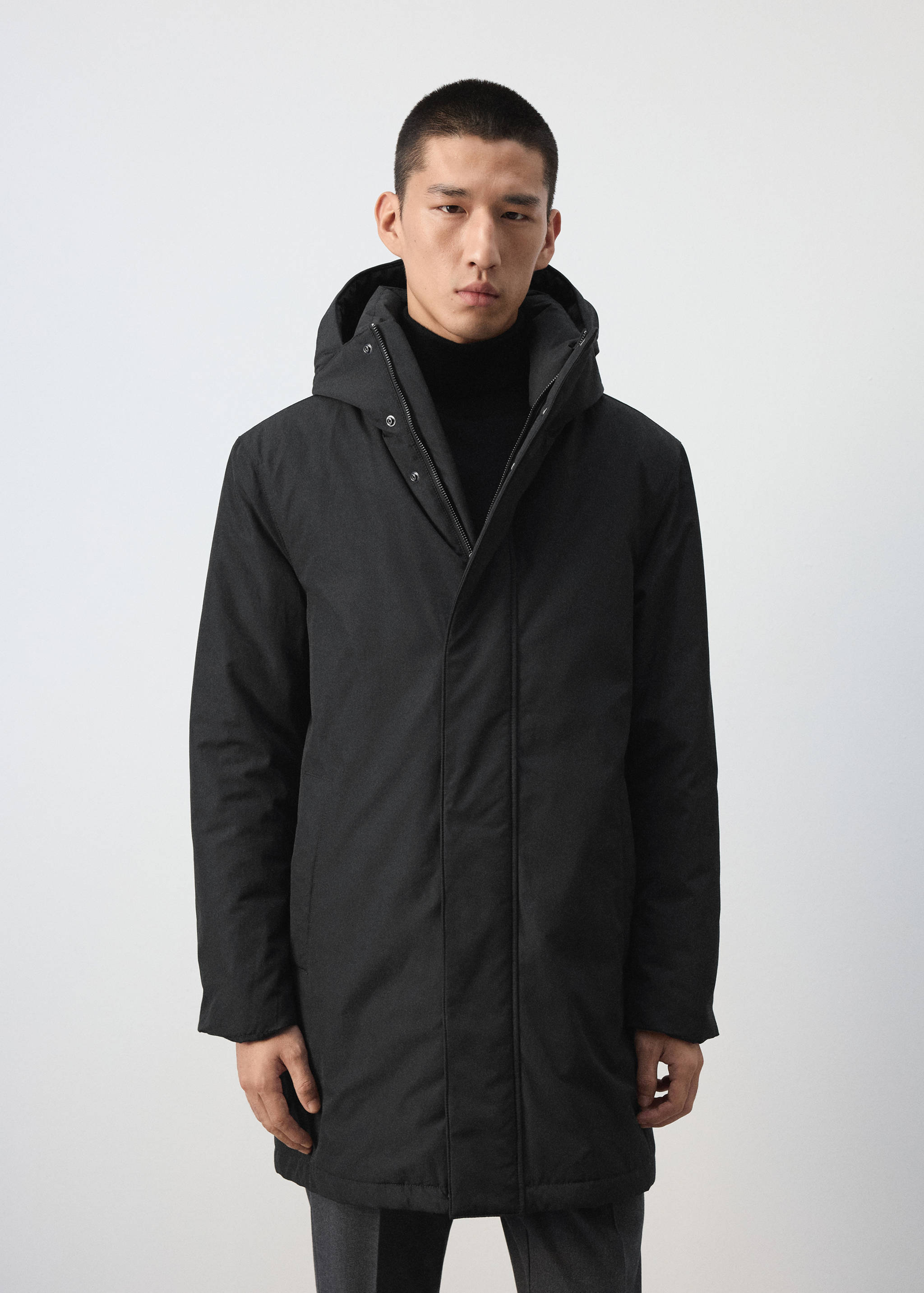 Black hooded parka with a zip and snap fastening.