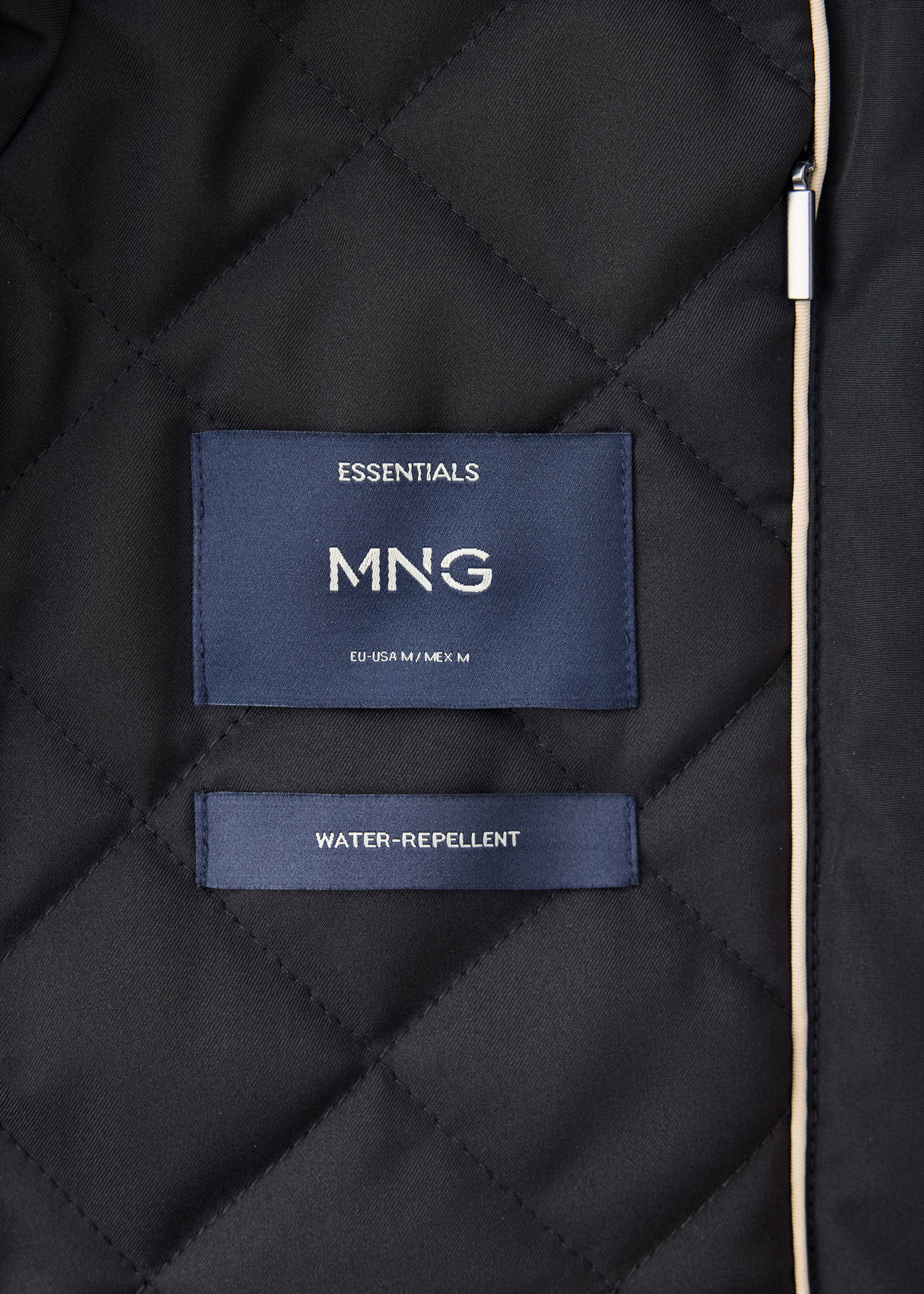 Parka fabric detail showing the quilted interior and branding labels.
