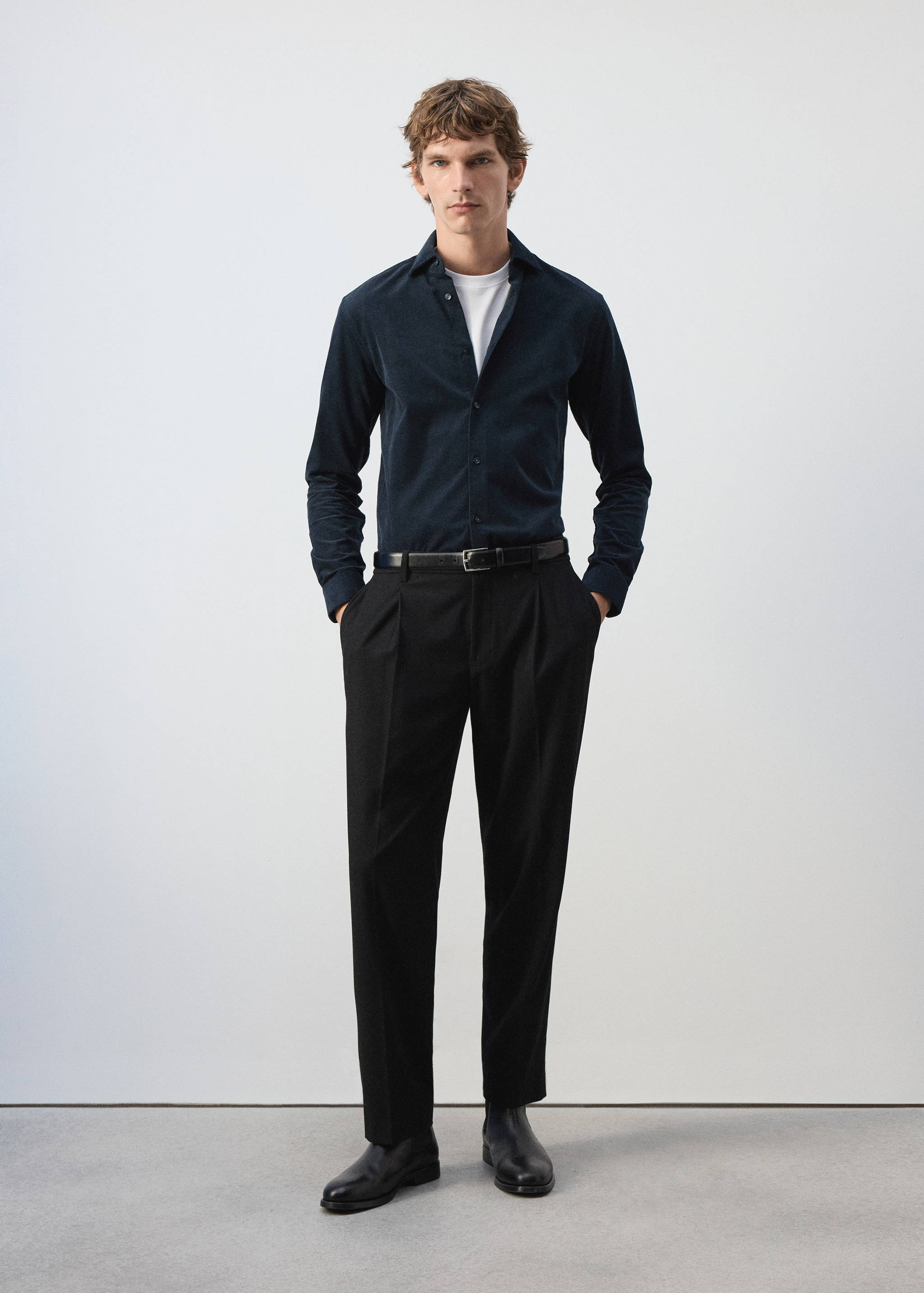 Dark navy blue long-sleeved shirt worn with a white t-shirt and black trousers.