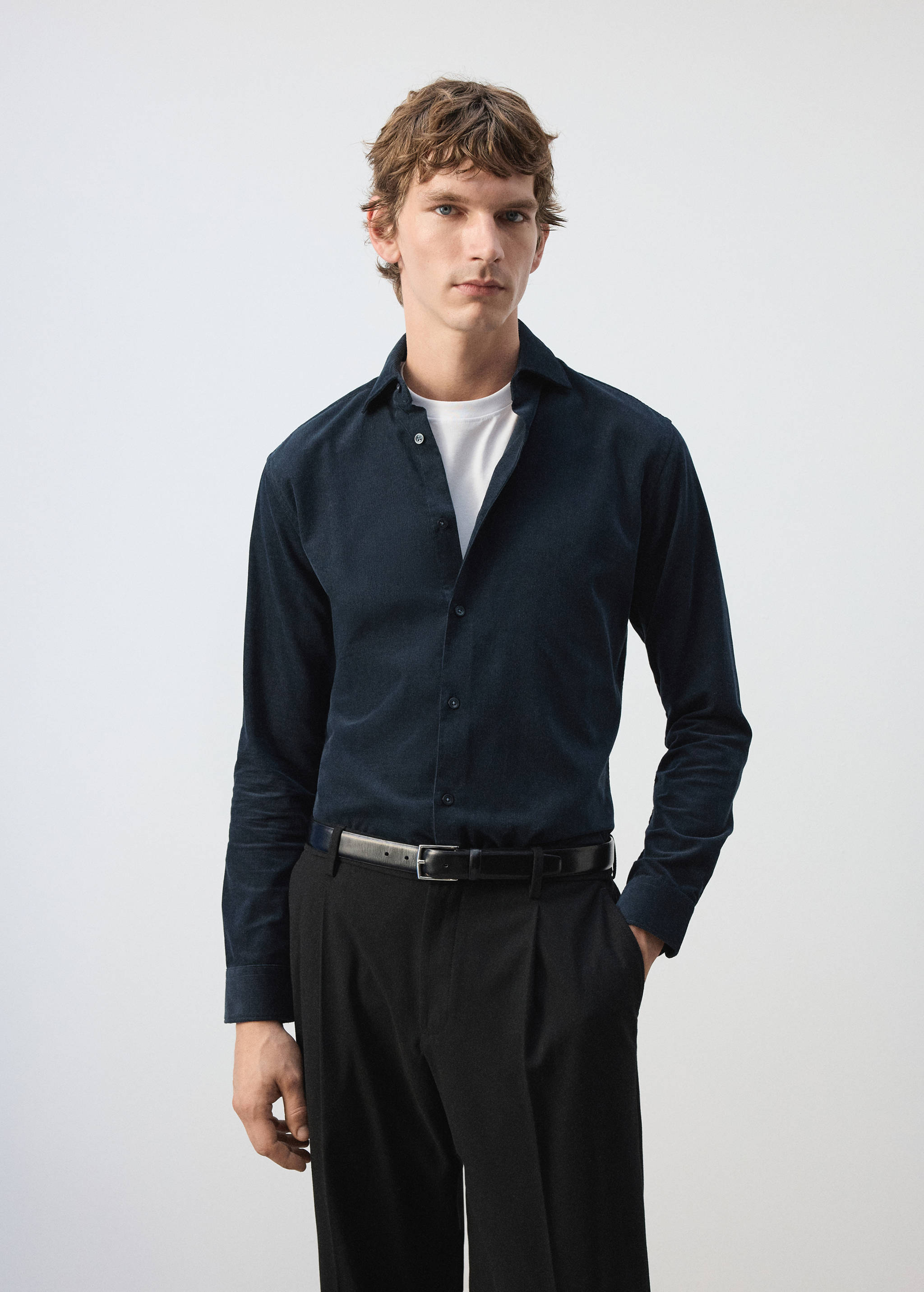 Dark navy blue long-sleeved shirt with a collar and button front worn by a model.