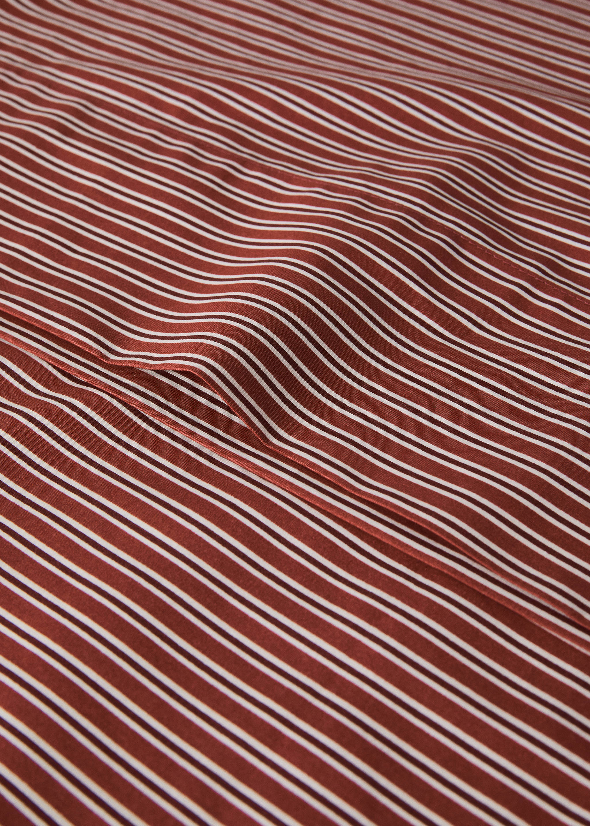 Rust-brown and white striped pillowcase in a close-up product view.