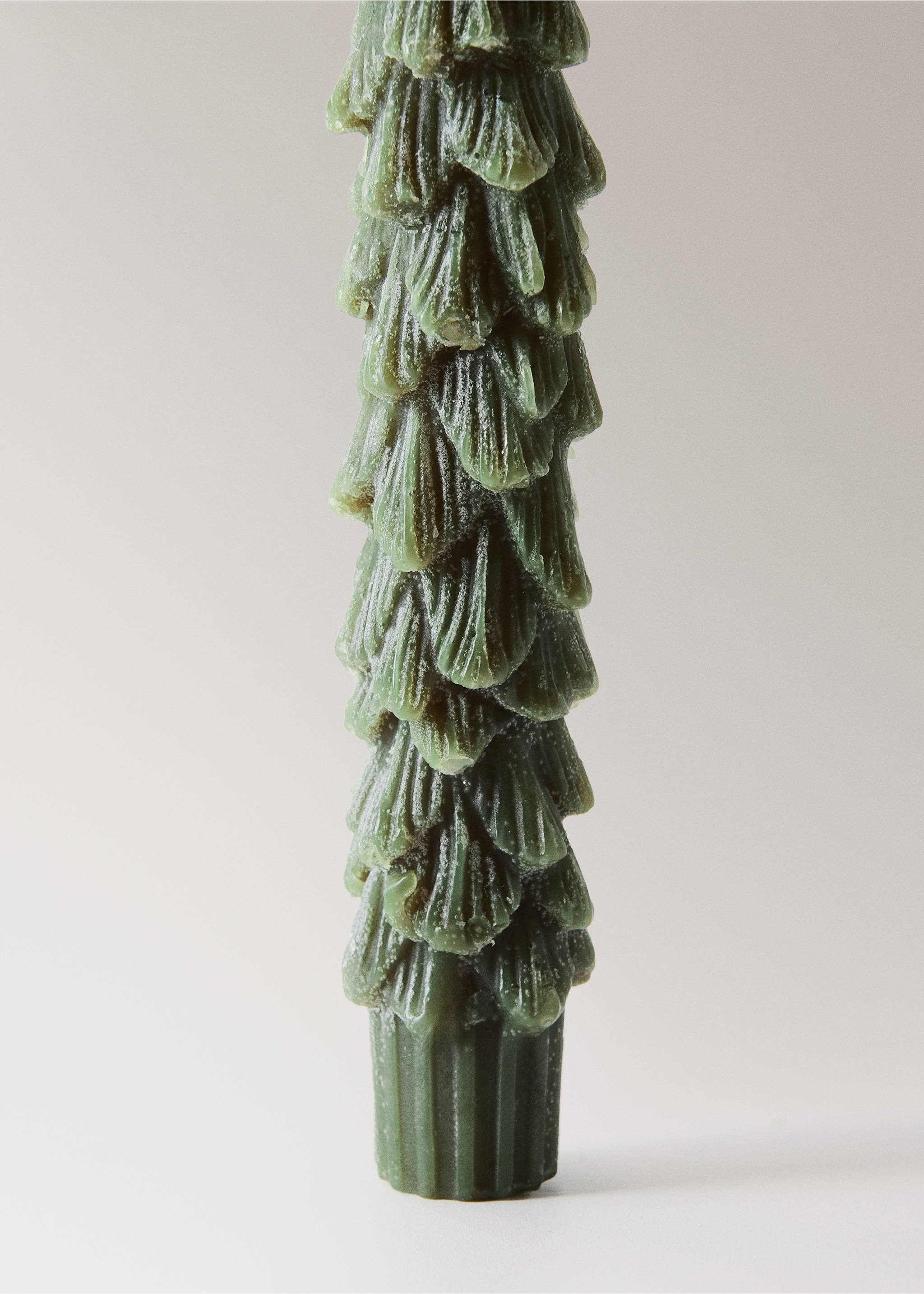 Close-up of a green Christmas tree candle with textured tiered fronds., Green. Ref: 37097889-00.