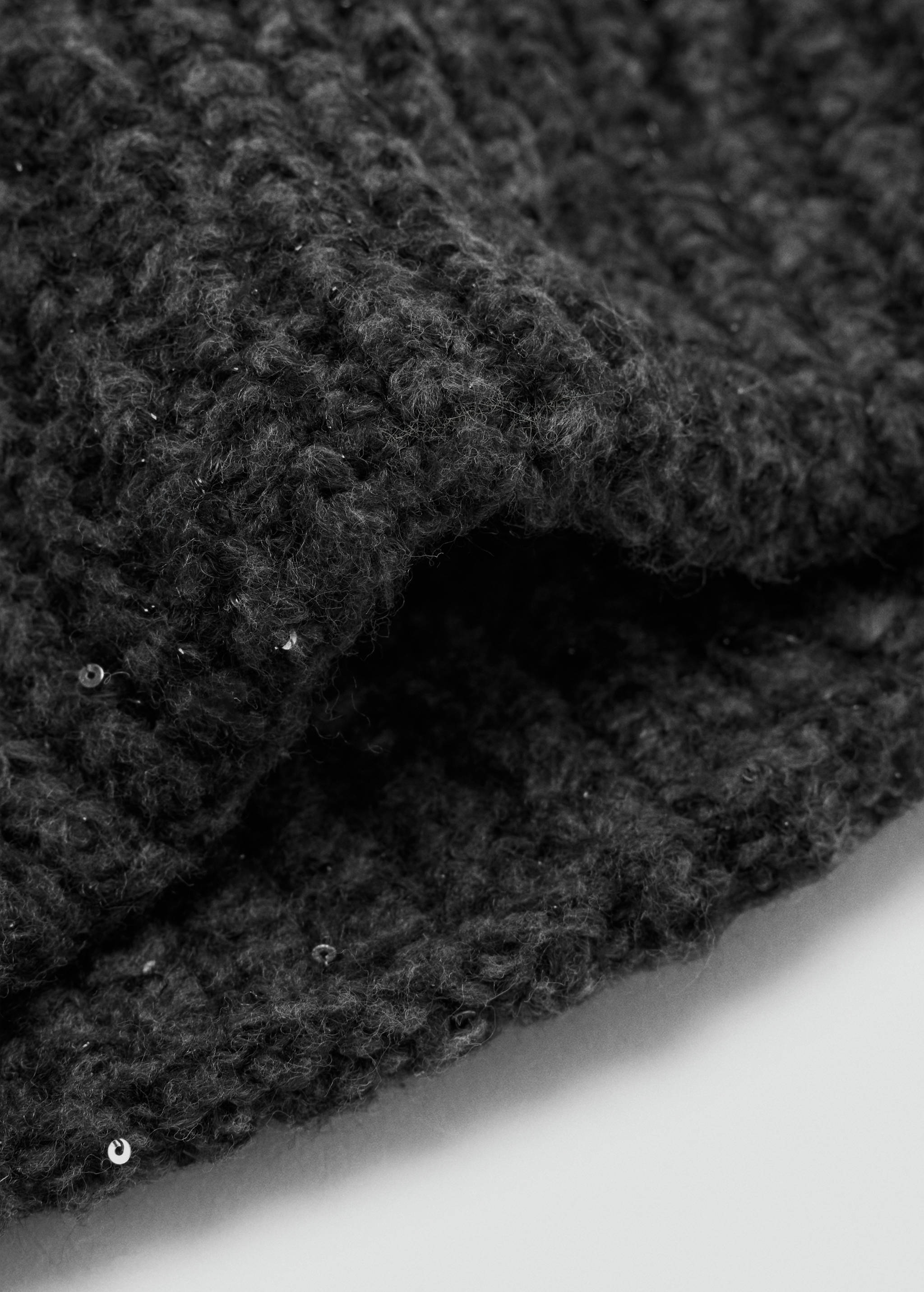 Dark grey knit beanie with textured ribbed fabric and subtle sequins.