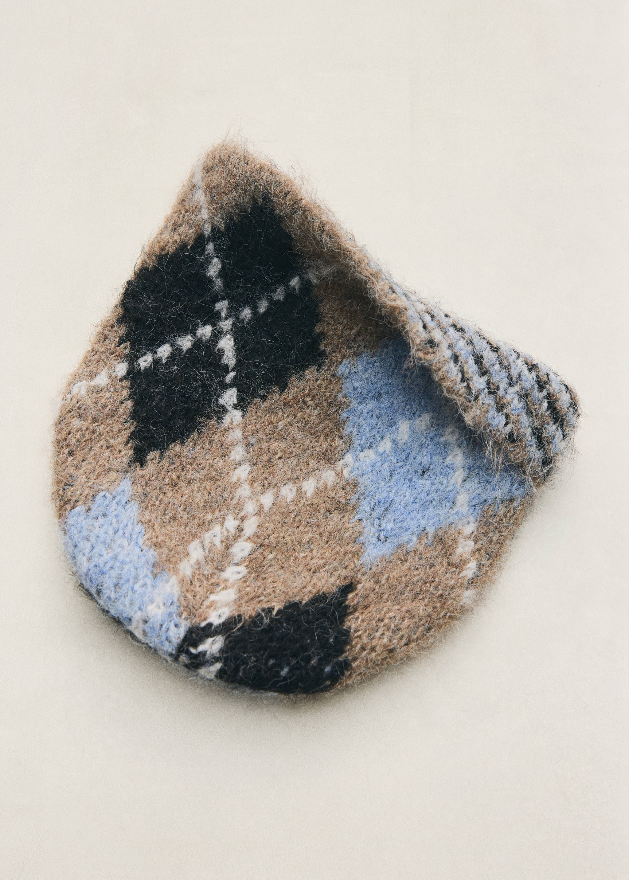 Fluffy knit beanie with a brown, black, and blue argyle pattern.