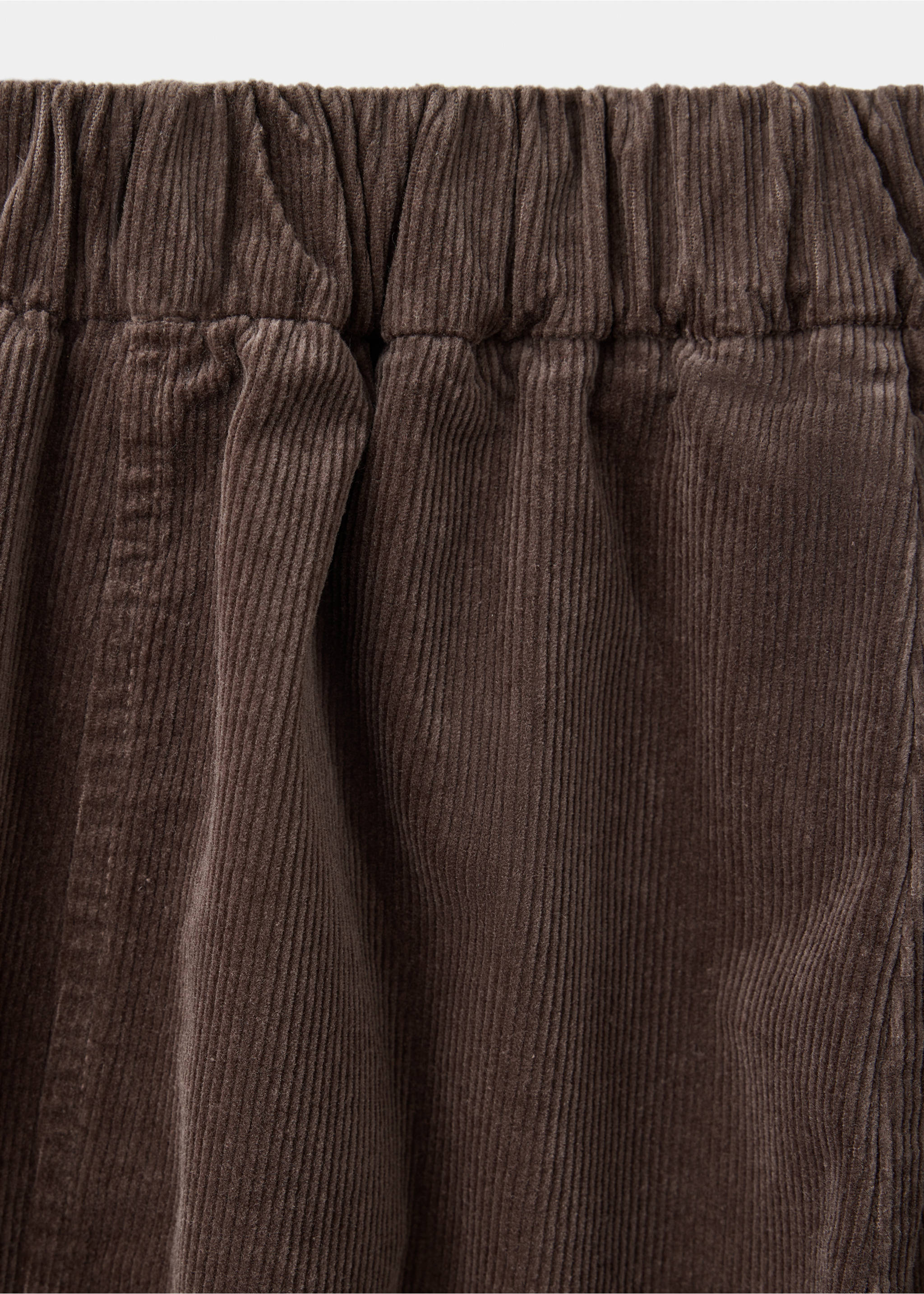 Brown corduroy trousers detail showing the textured fabric and elasticated waistband., Brown. Ref: 37097908-00.