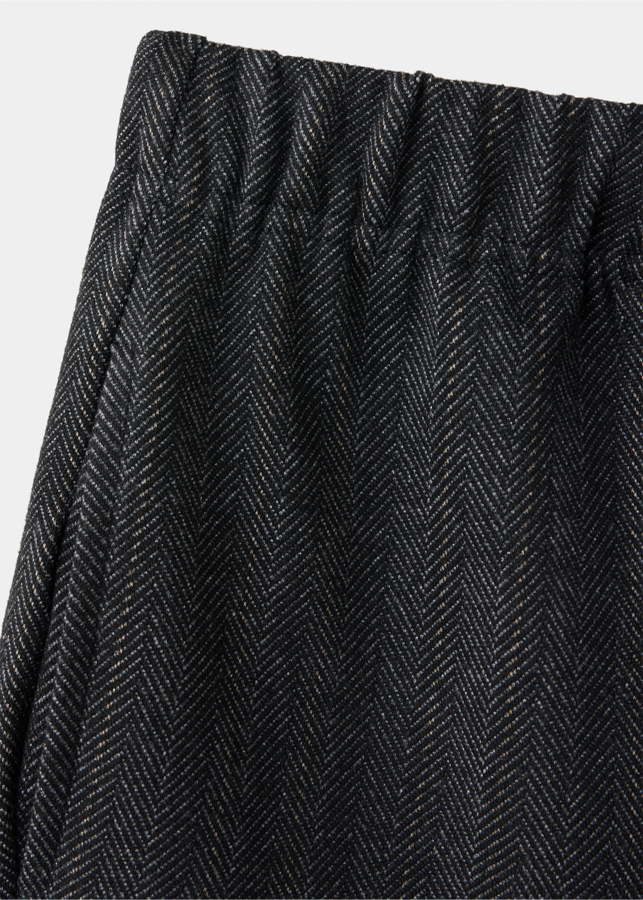 Close-up of children's dark herringbone trousers with an elasticated waist., Charcoal. Ref: 37097910-00.
