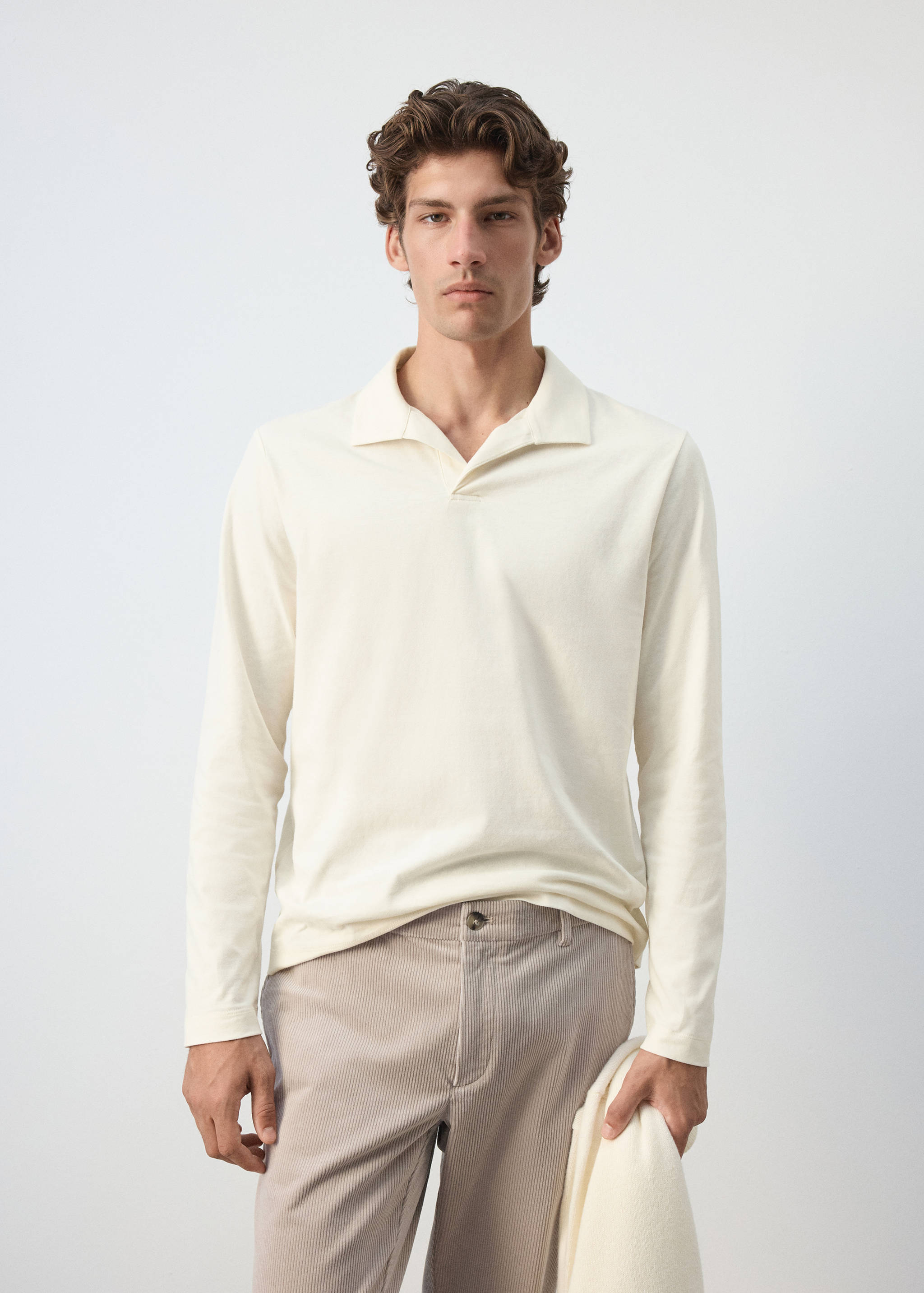 Off-white long-sleeved polo shirt with an open collar.