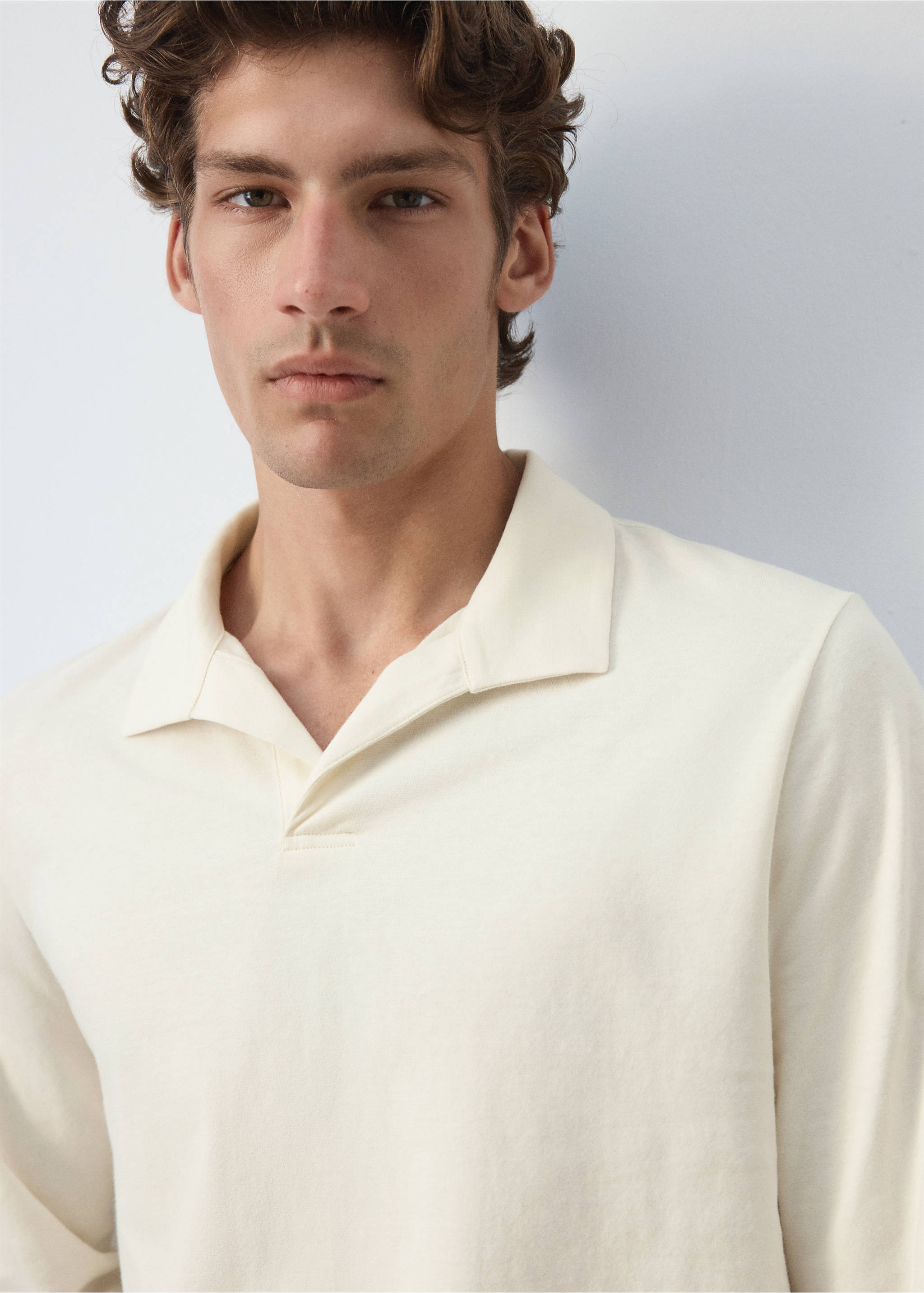 Close-up of a model wearing an off-white long-sleeved polo shirt., Off White. Ref: 37097911-00.
