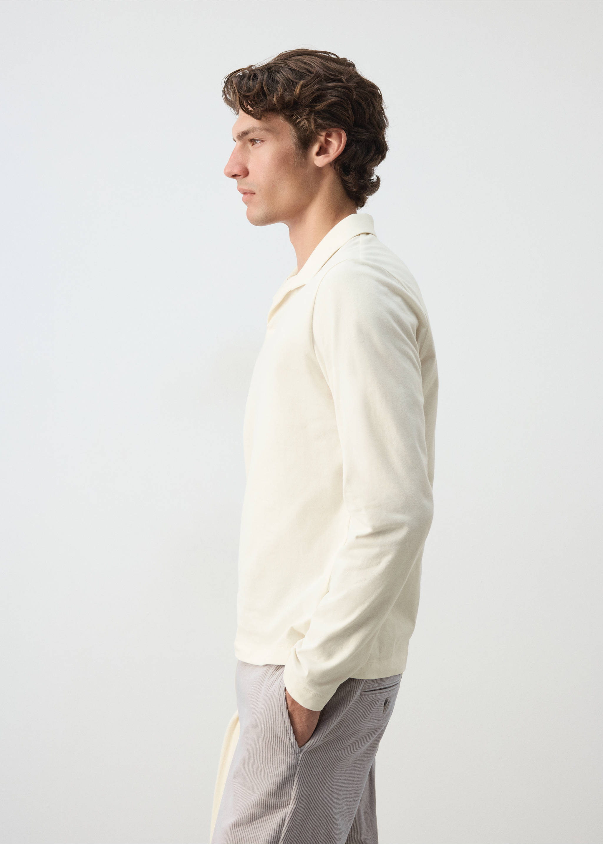 Cream long-sleeved polo shirt with a classic collar and v-neckline, shown in side profile., Off White. Ref: 37097911-00.