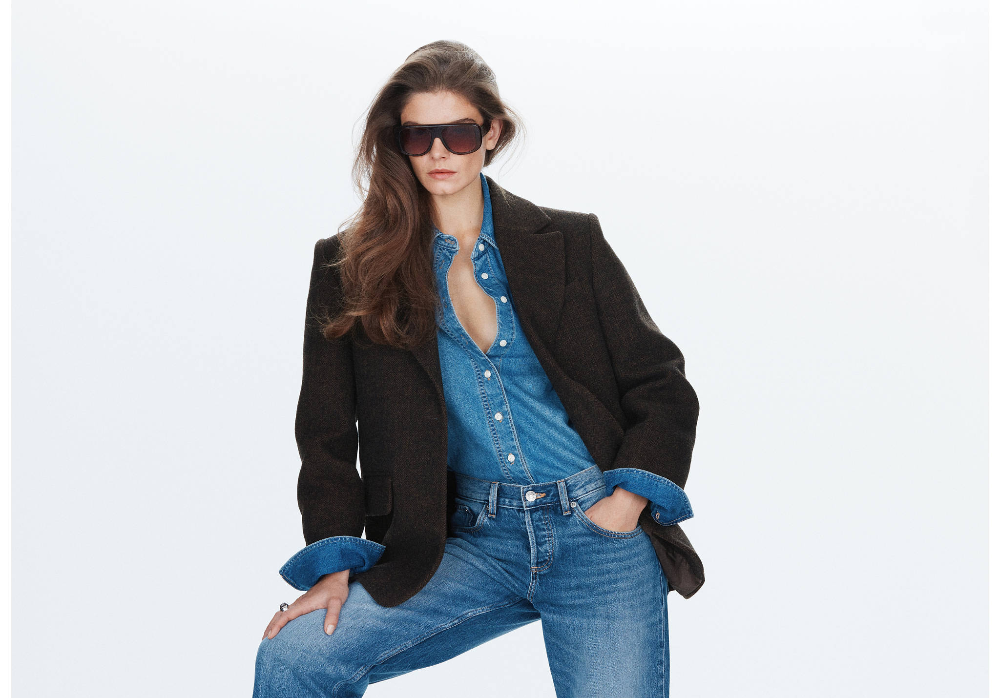 Dark brown blazer worn over a blue denim shirt and trousers.