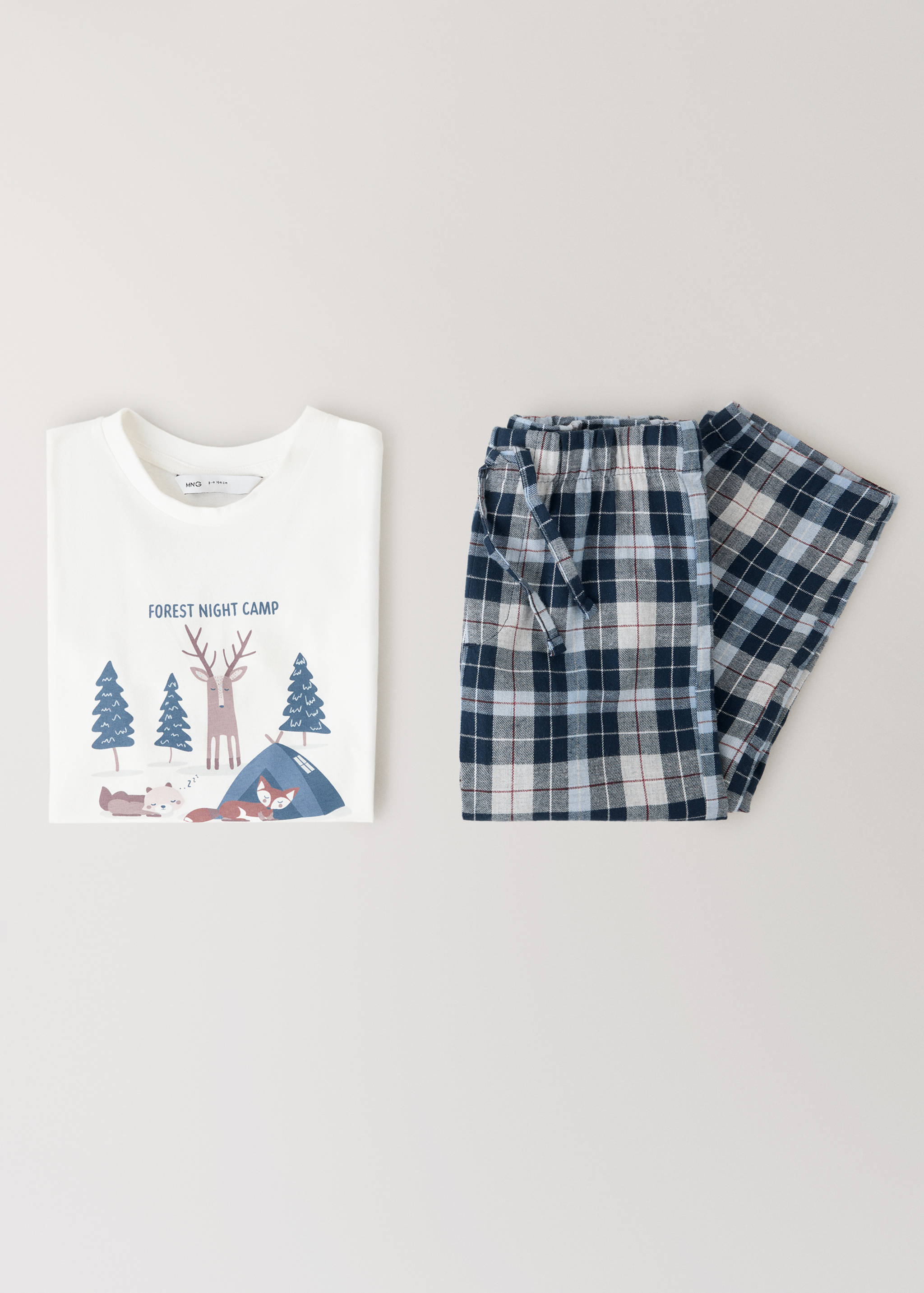 Kids' pyjama set with a white graphic t-shirt and blue plaid trousers.