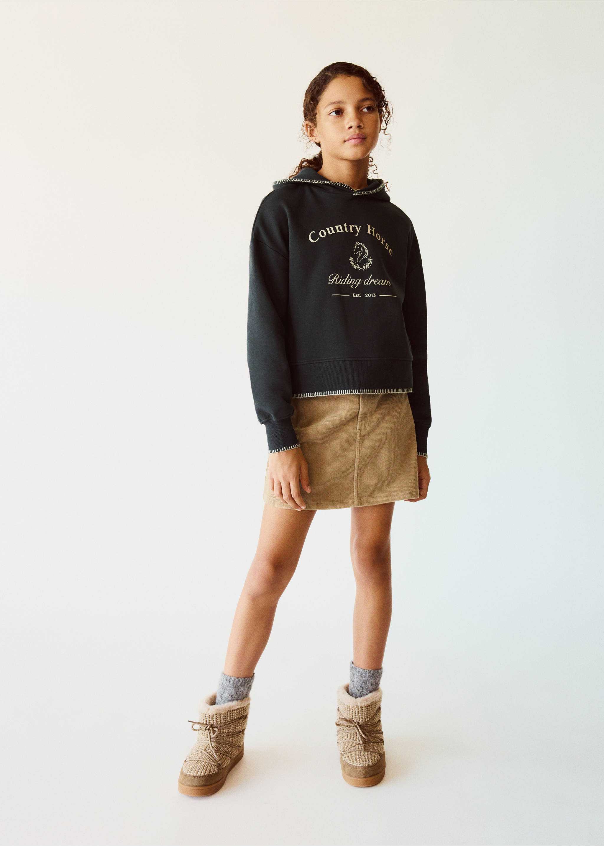 Dark green hooded sweatshirt with contrast stitching and graphic text, worn with a beige corduroy skirt., Charcoal. Ref: 37097924-00.