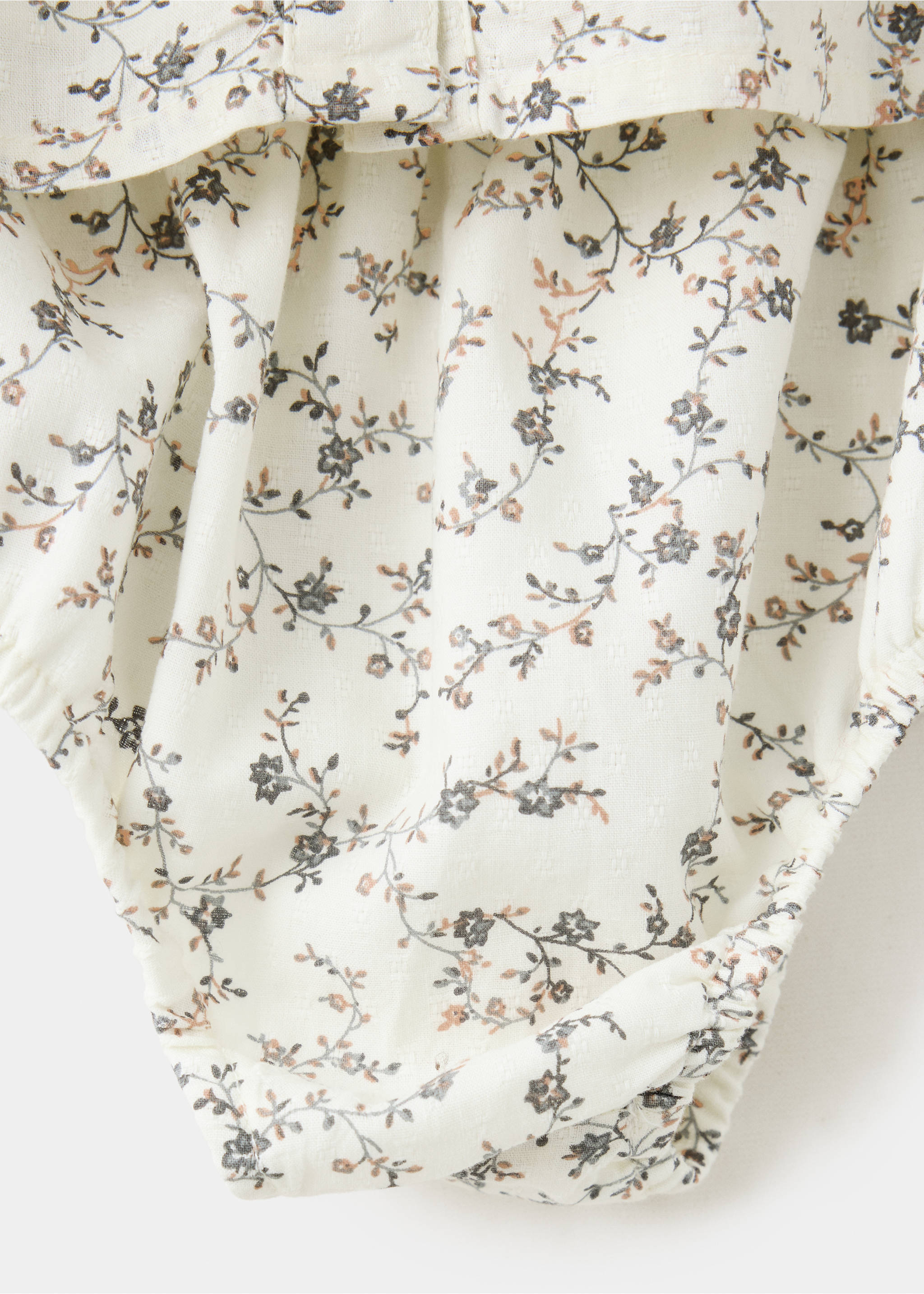 Close-up of the cream floral print fabric detail on a kids' dress., Ecru. Ref: 37097925-00.