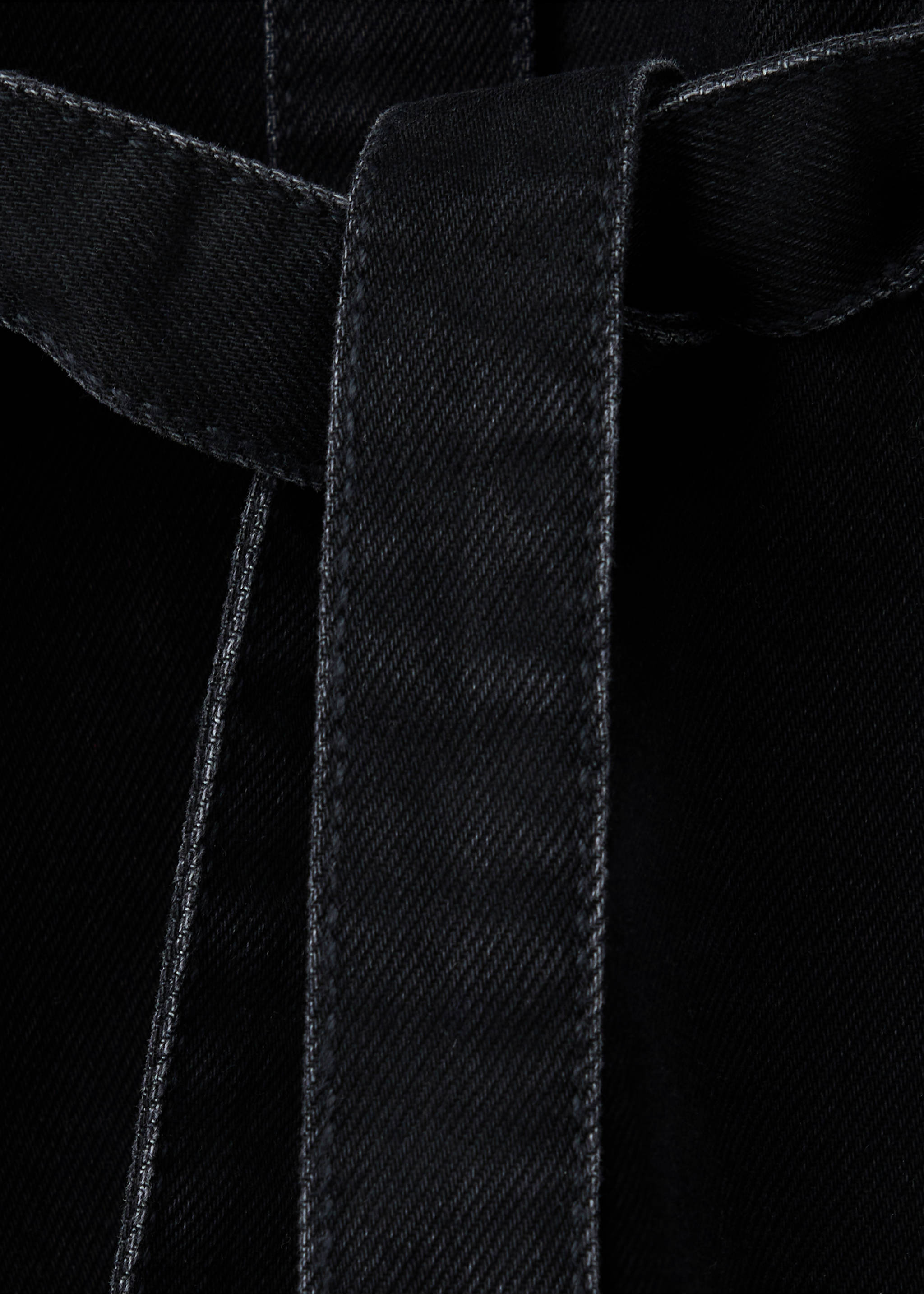 Close-up of a black denim dress fabric texture and belt detail., Black denim. Ref: 37097932-00.
