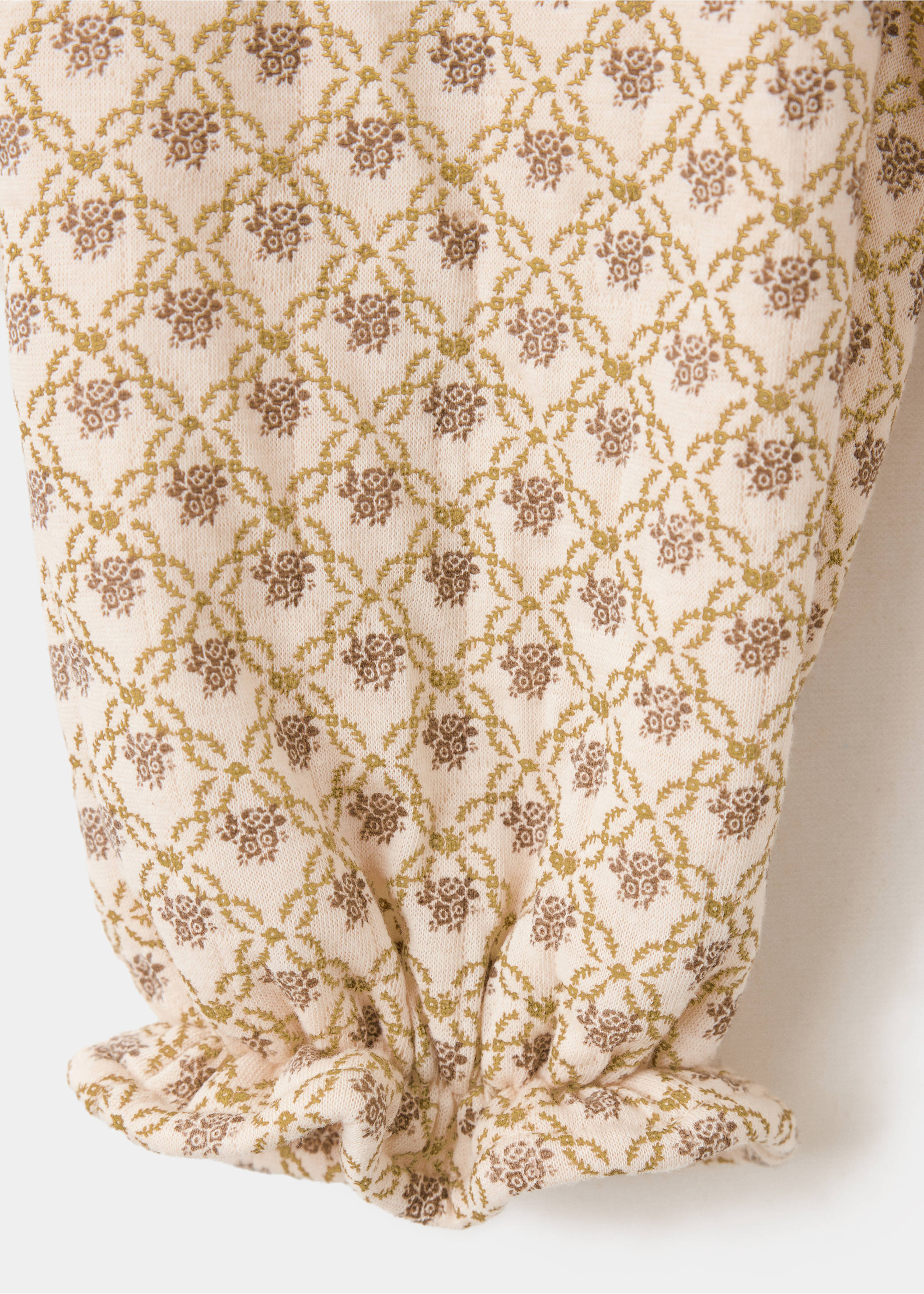 Close-up of fabric detail on kids' floral joggers with an elasticated cuff., Beige. Ref: 37097935-00.